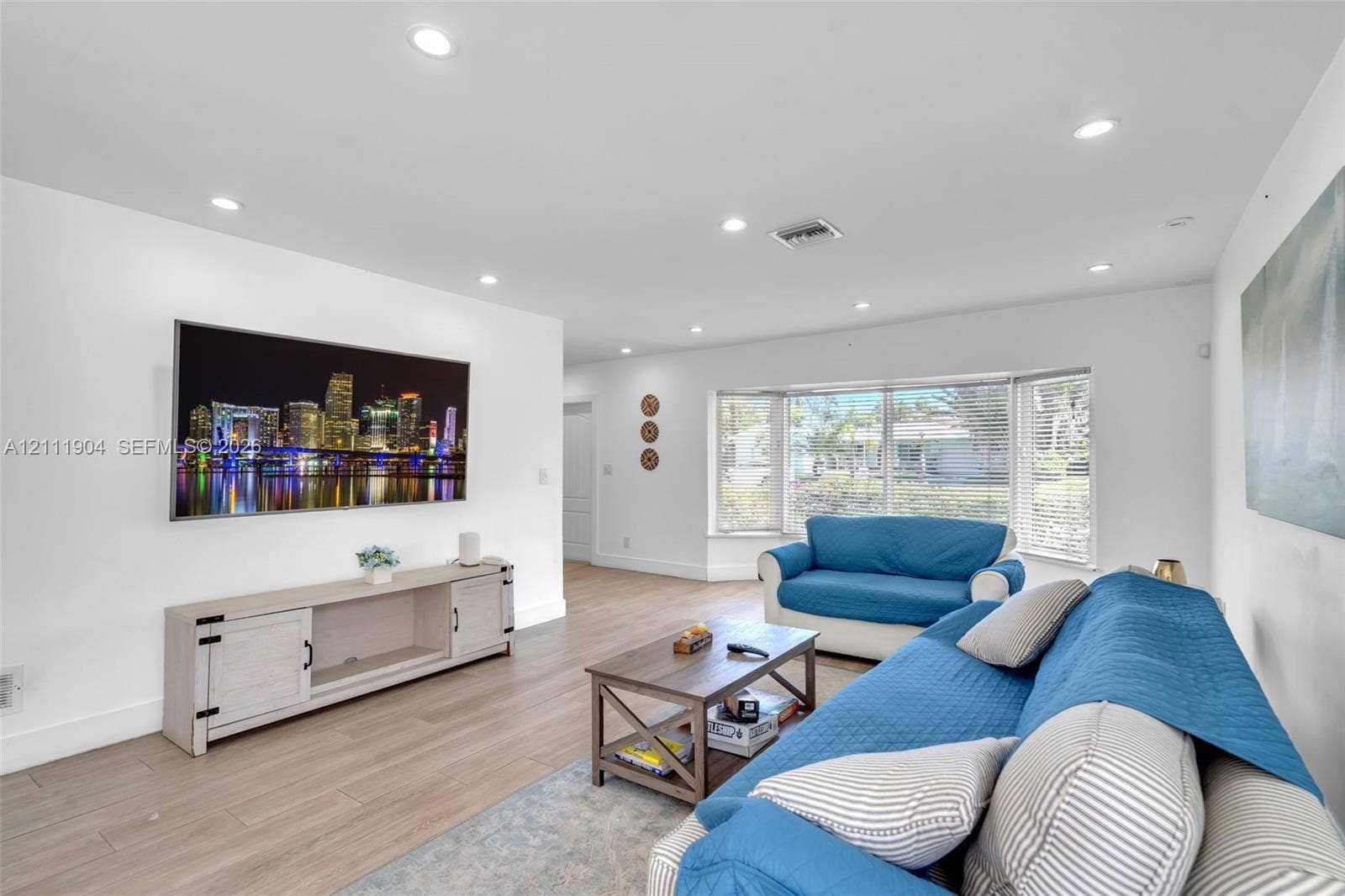 821 Harrison Street, Hollywood, FL 33019 Living area featuring light-toned wood-finish flooring, recessed lighting, and a bay window