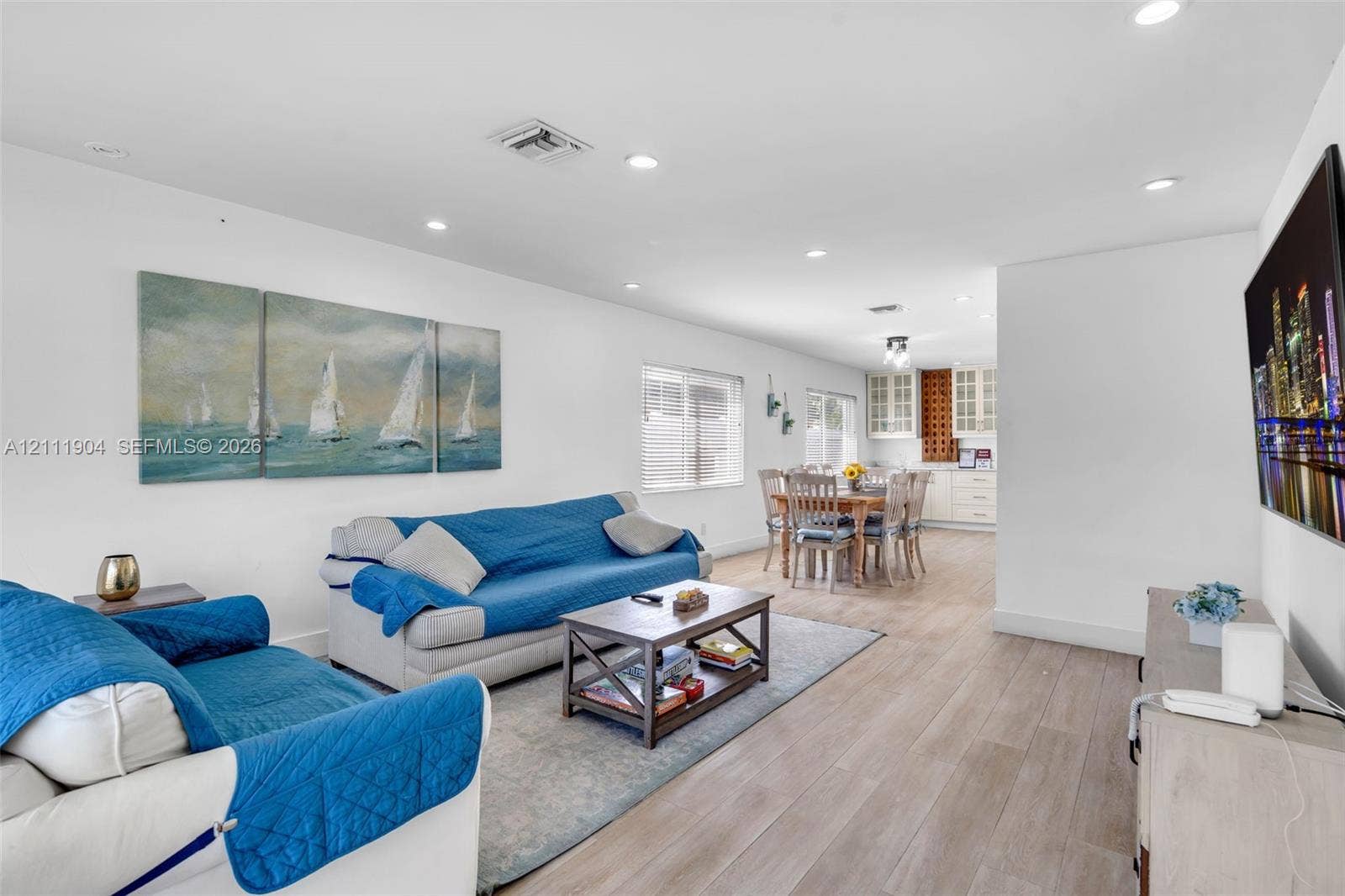 821 Harrison Street, Hollywood, FL 33019 Open-concept interior featuring wood-finish flooring, recessed lighting, and white cabinetry with glass-front uppers