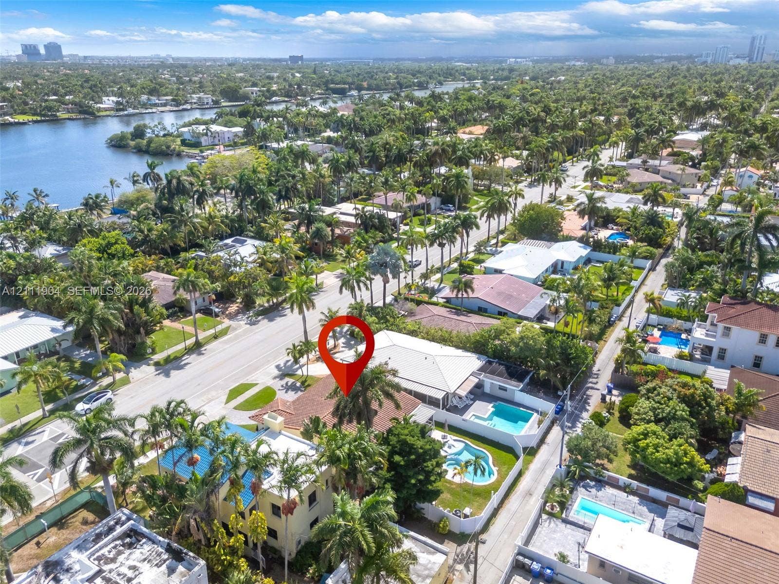 821 Harrison Street, Hollywood, FL 33019 Aerial perspective showcasing a residential property with a tiled roof, a private swimming pool, and mature palm landscaping