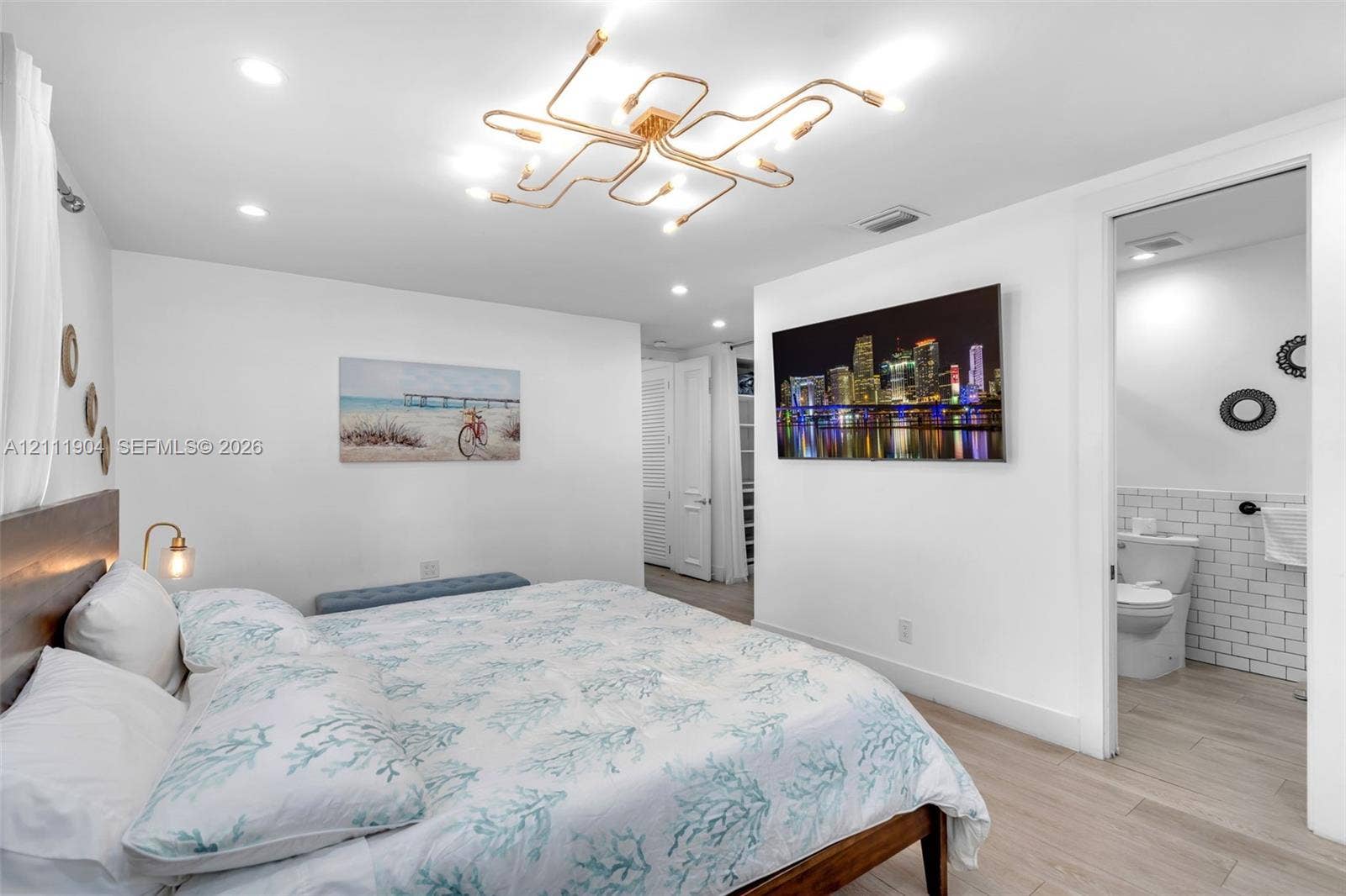 821 Harrison Street, Hollywood, FL 33019 Contemporary interior space featuring light wood-finish flooring, a multi-arm geometric flush-mount light fixture, and recessed ceiling lighting