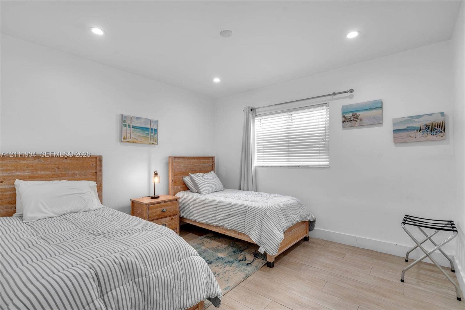 821 Harrison Street, Hollywood, FL 33019 Room featuring recessed lighting, wood-finish flooring, and a window with horizontal blinds