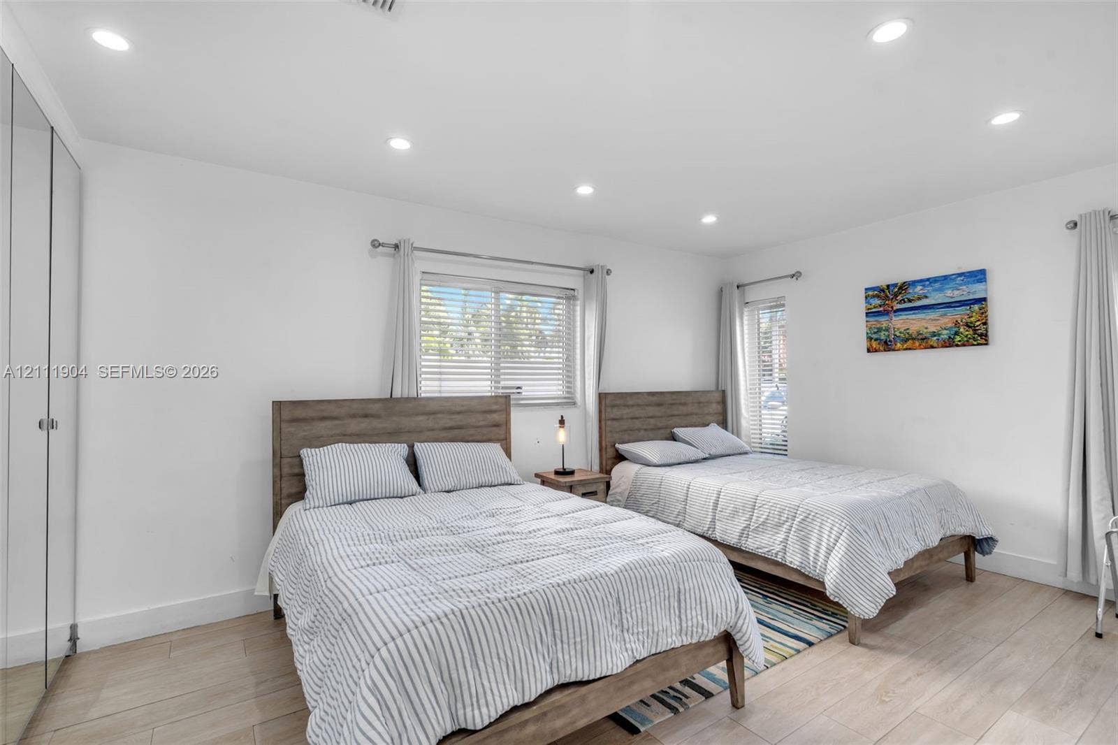 821 Harrison Street, Hollywood, FL 33019 Neutral interior featuring recessed lighting, wood-finish flooring, and floor-to-ceiling mirrored closet doors