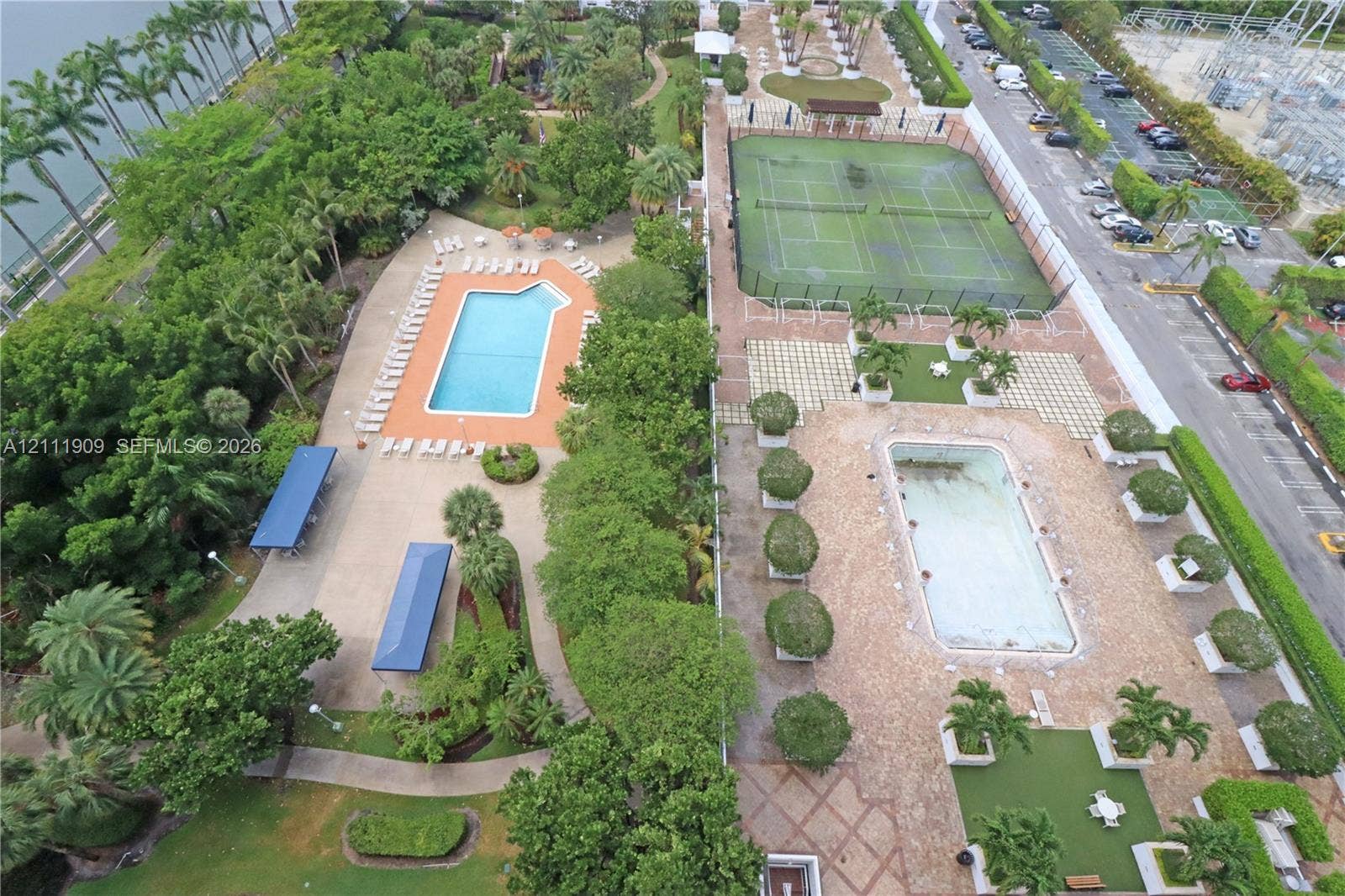 2851 NE 183rd Street, #1708E, Aventura, FL 33160 Common recreational grounds featuring two swimming pools, two tennis courts, paved walkways, and mature landscaping