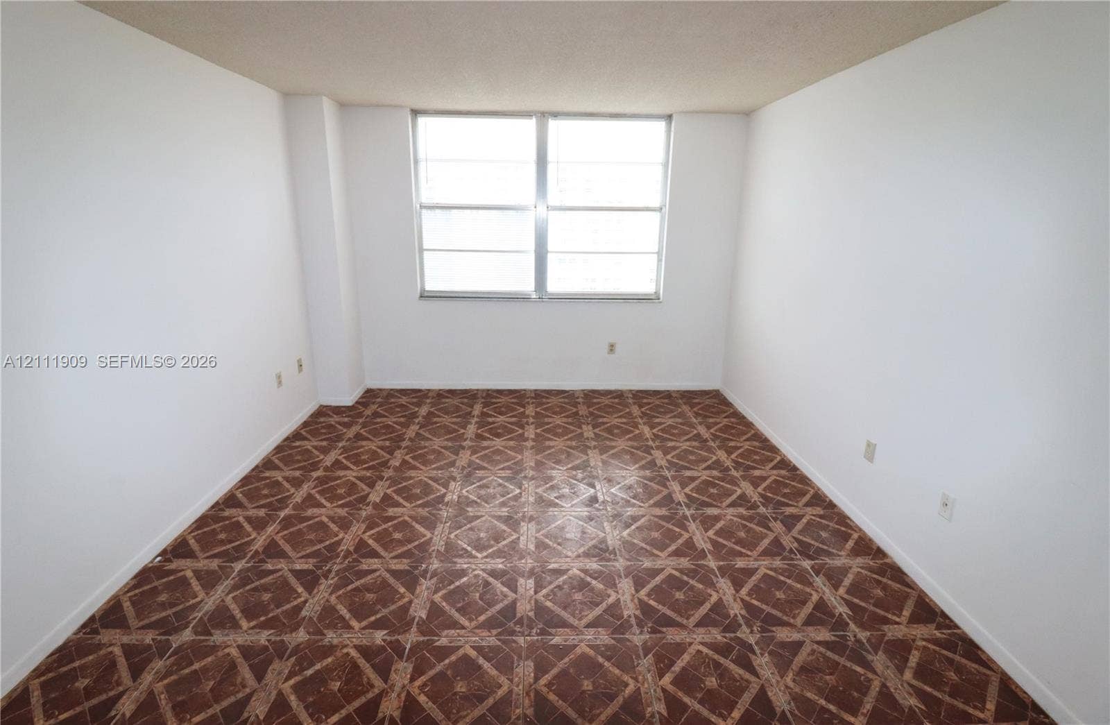 2851 NE 183rd Street, #1708E, Aventura, FL 33160 Interior space featuring patterned tile flooring and a large aluminum-frame window