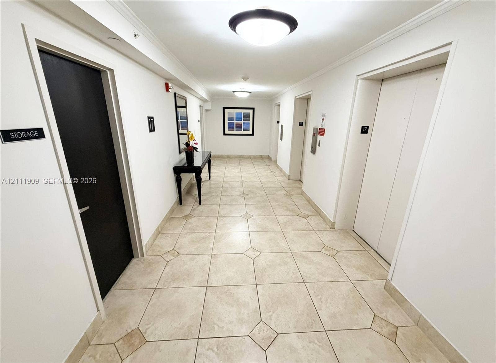 2851 NE 183rd Street, #1708E, Aventura, FL 33160 Hallway featuring large-format tile flooring with diamond-pattern accents, recessed ceiling lighting, and dual elevator access