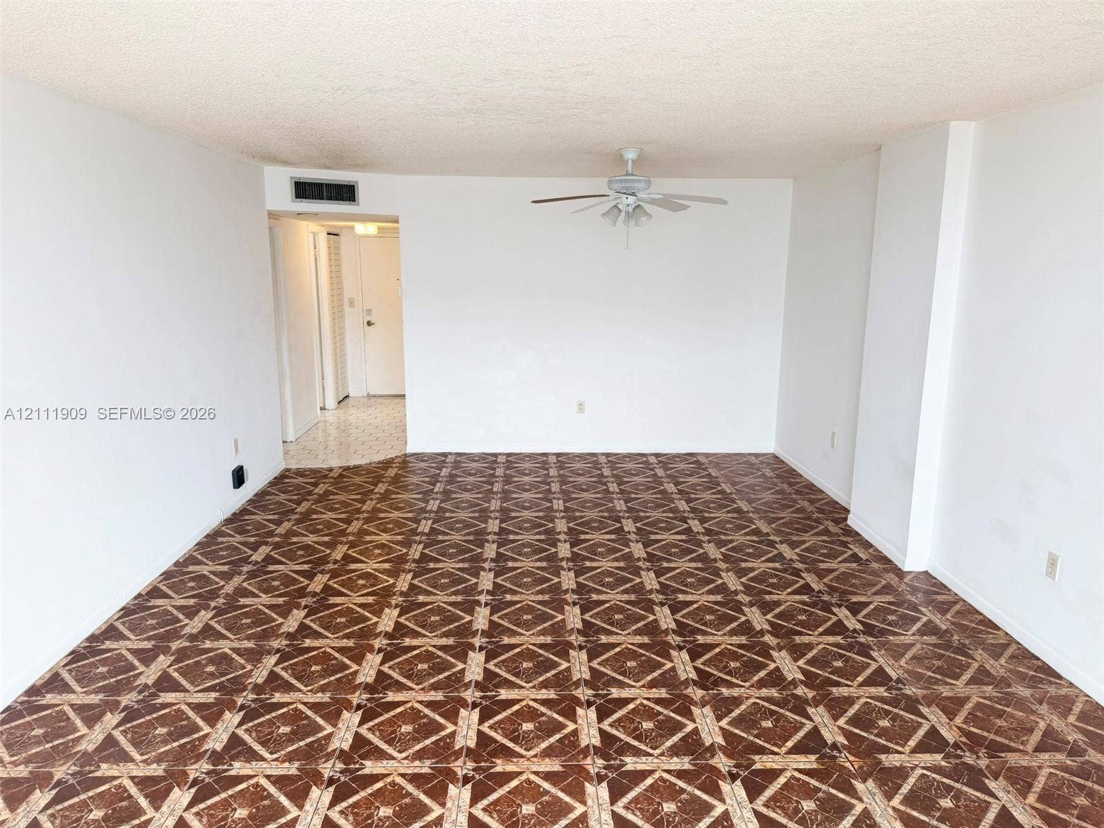 2851 NE 183rd Street, #1708E, Aventura, FL 33160 Spacious interior featuring patterned tile flooring, a centered ceiling fan with integrated lighting, and neutral wall finishes
