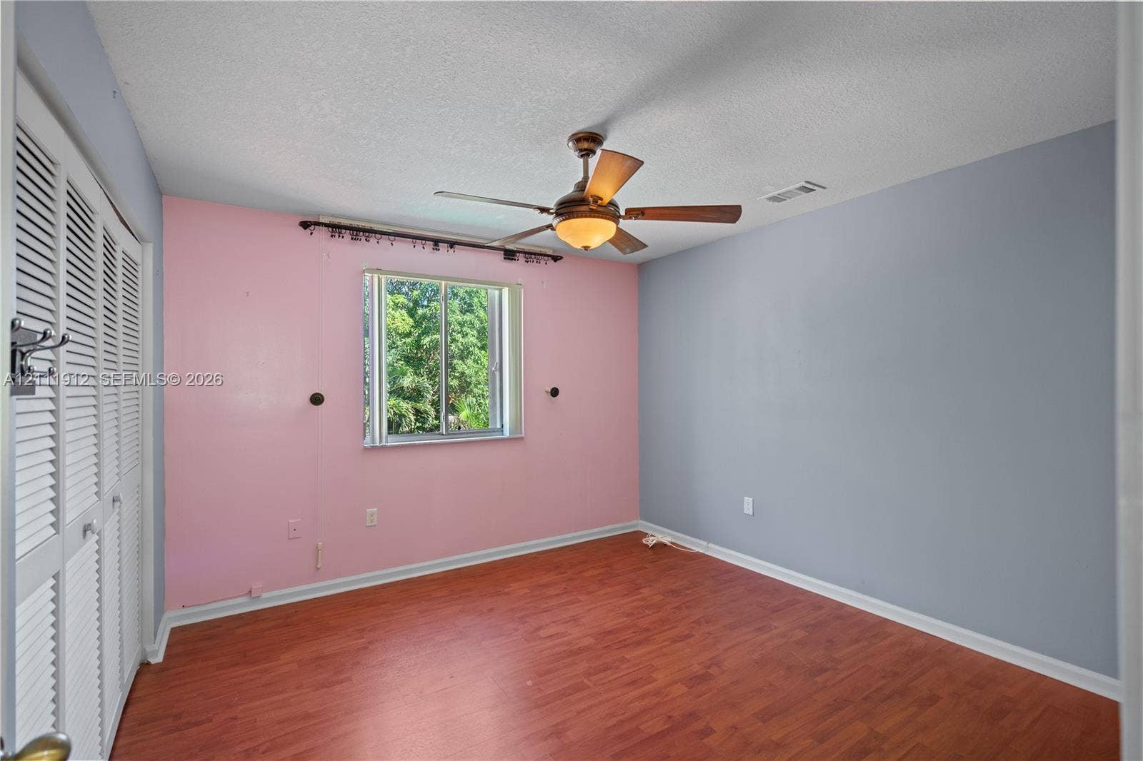 15681 SW 147th Court, Miami, FL 33187 Wood-finish flooring, ceiling fan with integrated lighting, and louvered-style closet doors