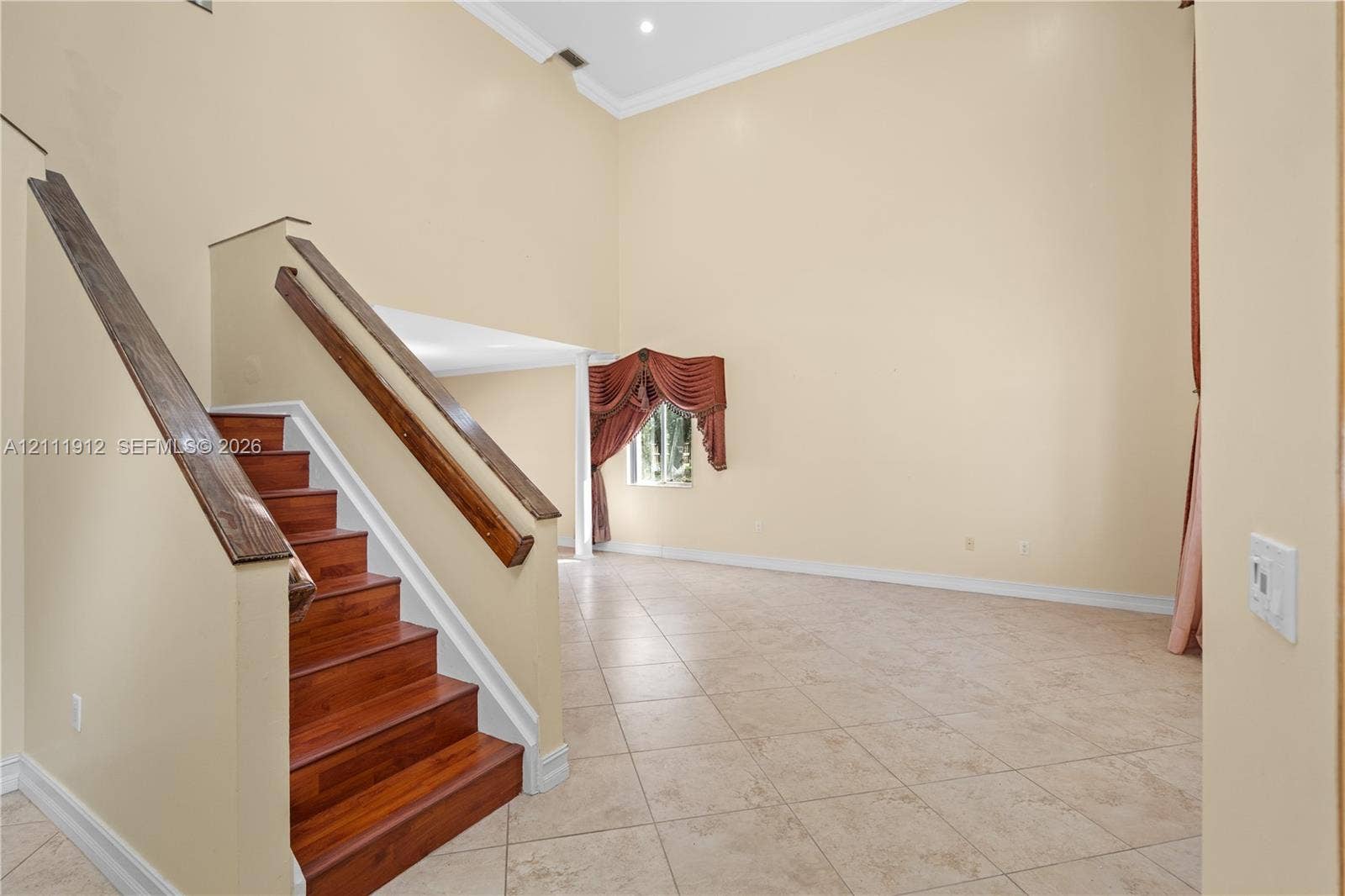15681 SW 147th Court, Miami, FL 33187 Vaulted ceilings, staircase with wood-finish treads and handrails, and tile flooring