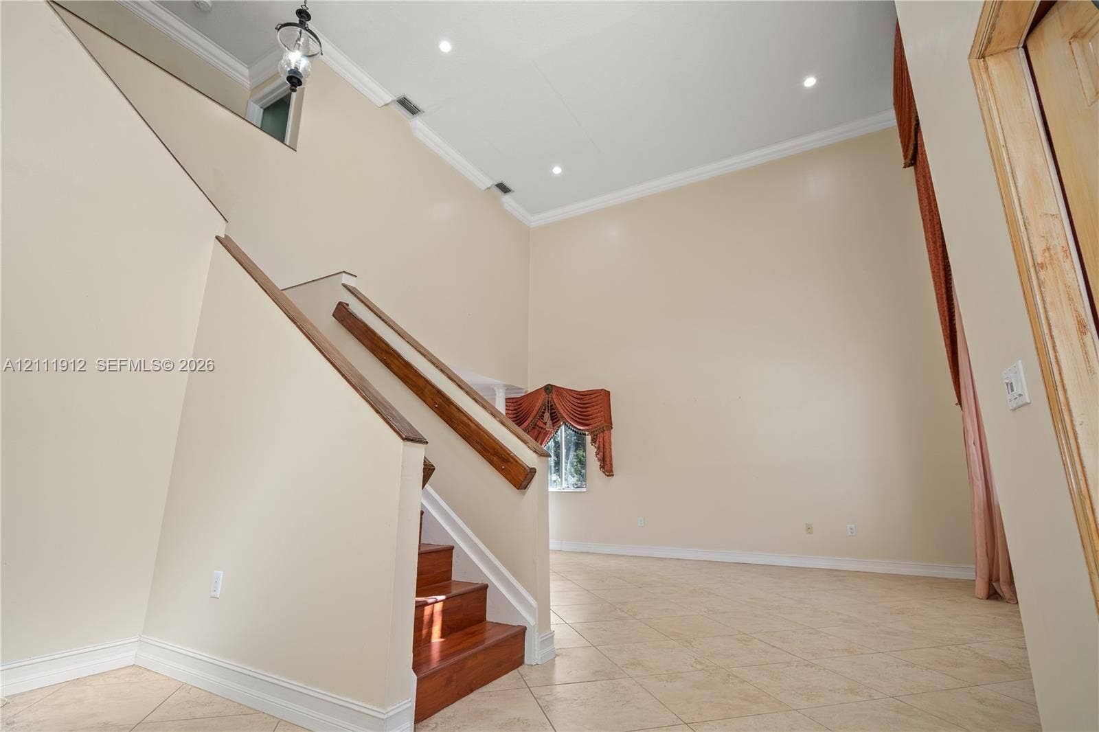 15681 SW 147th Court, Miami, FL 33187 Double-height ceiling, staircase with wood handrail, recessed lighting, and tile flooring