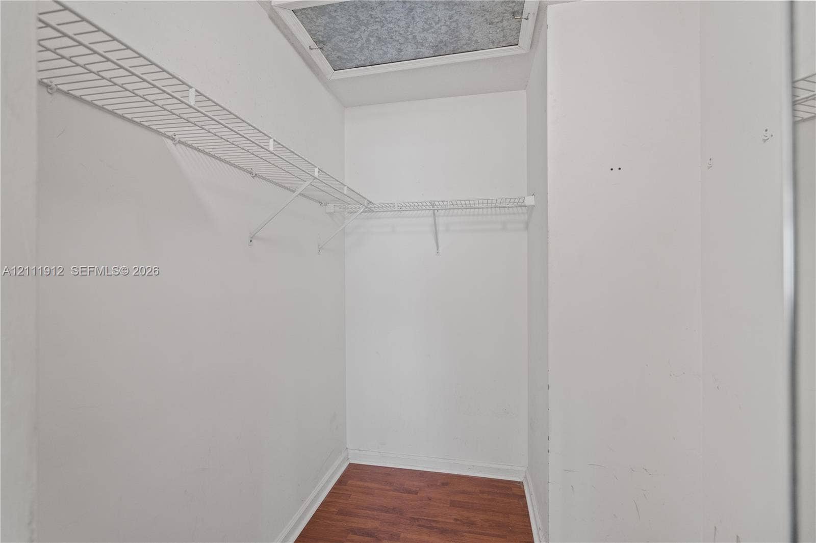 15681 SW 147th Court, Miami, FL 33187 Walk-in storage space featuring wire shelving and wood-finish flooring