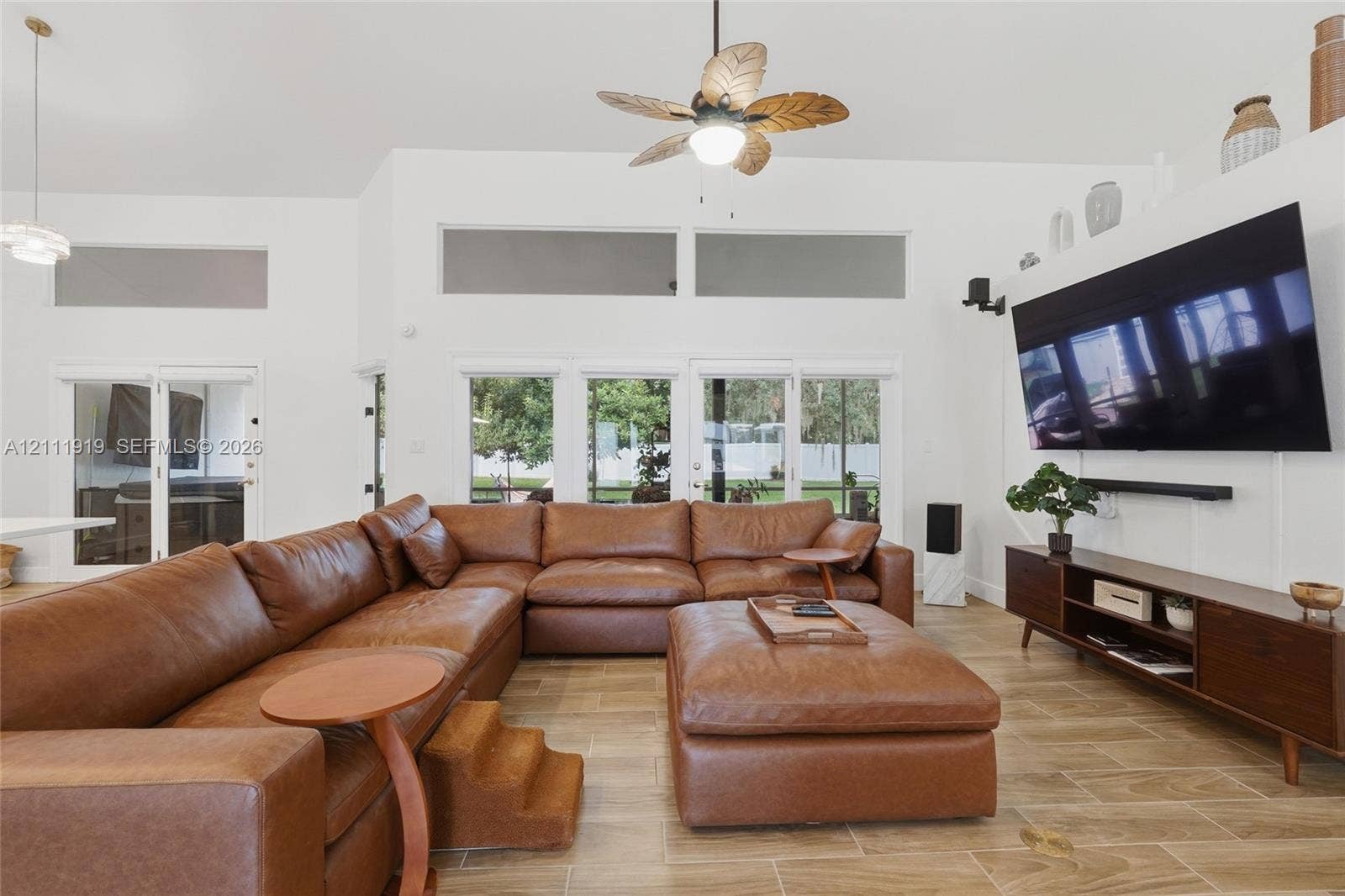 137 Arrowhead Lane, Haines City, FL 33844 Vaulted ceilings featuring clerestory windows, tile flooring, and a ceiling fan