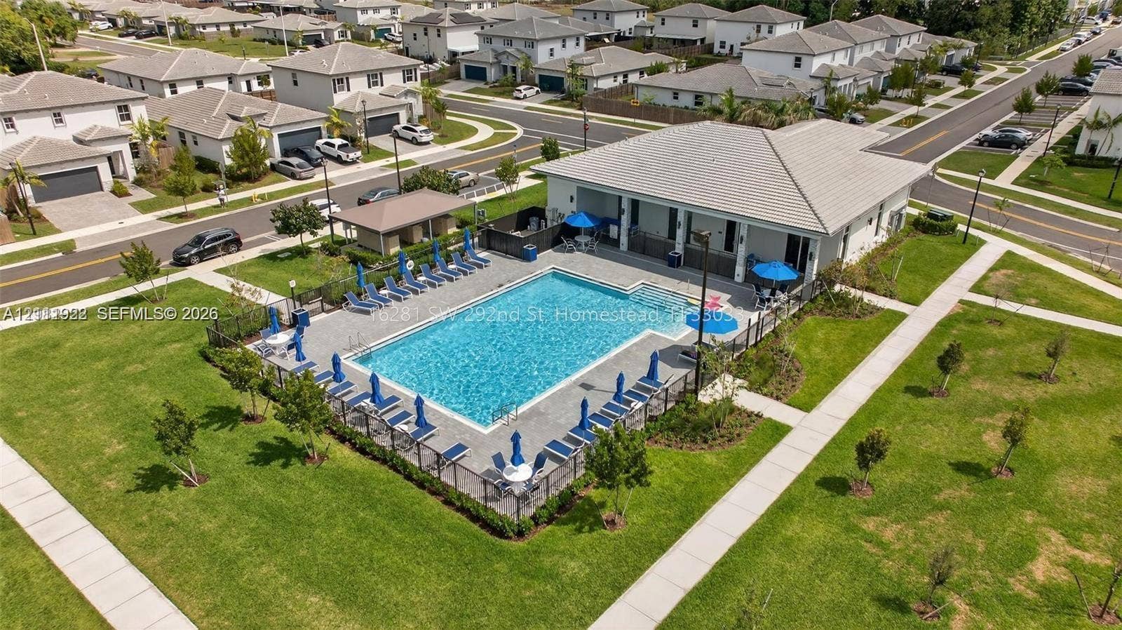 16281 SW 292nd Street, Homestead, FL 33033 Community recreation center featuring an outdoor swimming pool, concrete pool deck, covered pavilion, and surrounding landscaped grounds