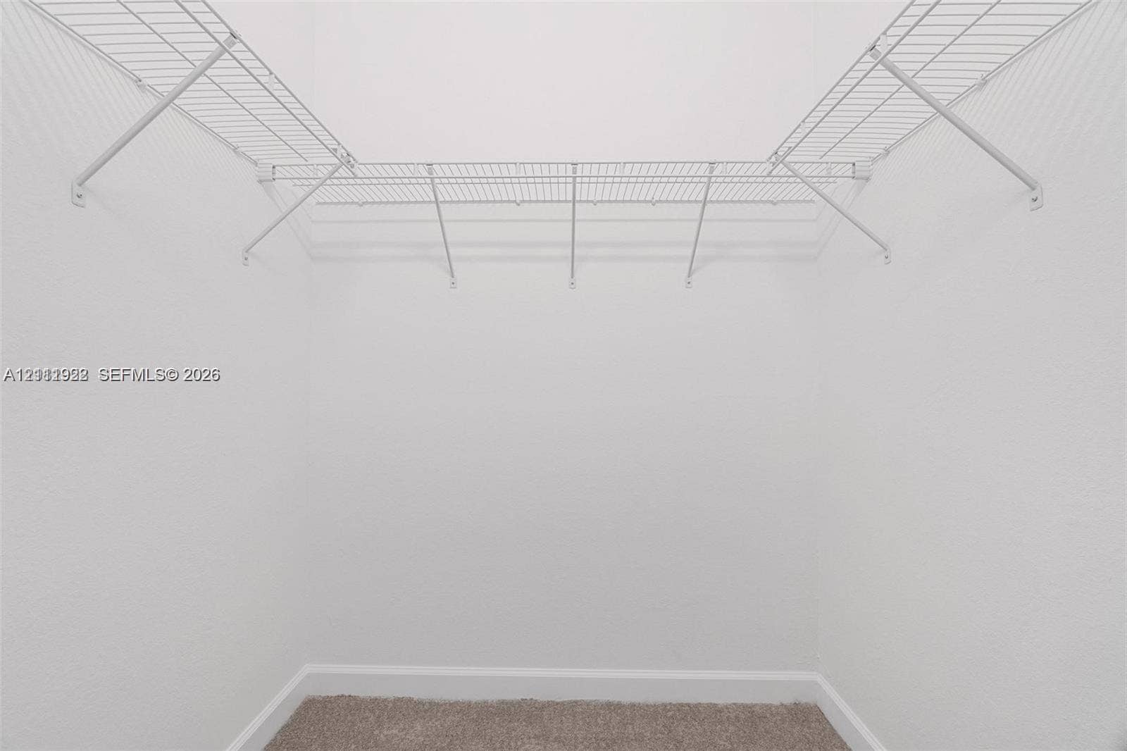 16281 SW 292nd Street, Homestead, FL 33033 Walk-in storage space featuring neutral carpeting and built-in white wire shelving