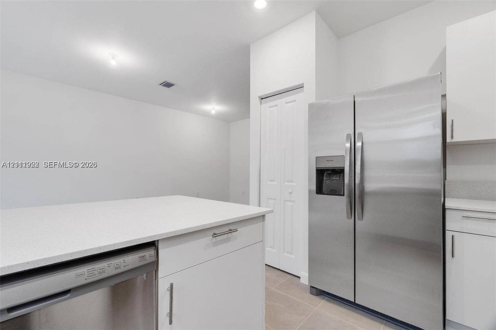16281 SW 292nd Street, Homestead, FL 33033 Kitchen featuring white shaker-style cabinetry, quartz countertops, stainless steel side-by-side refrigerator, stainless steel dishwasher, and recessed ceiling lighting