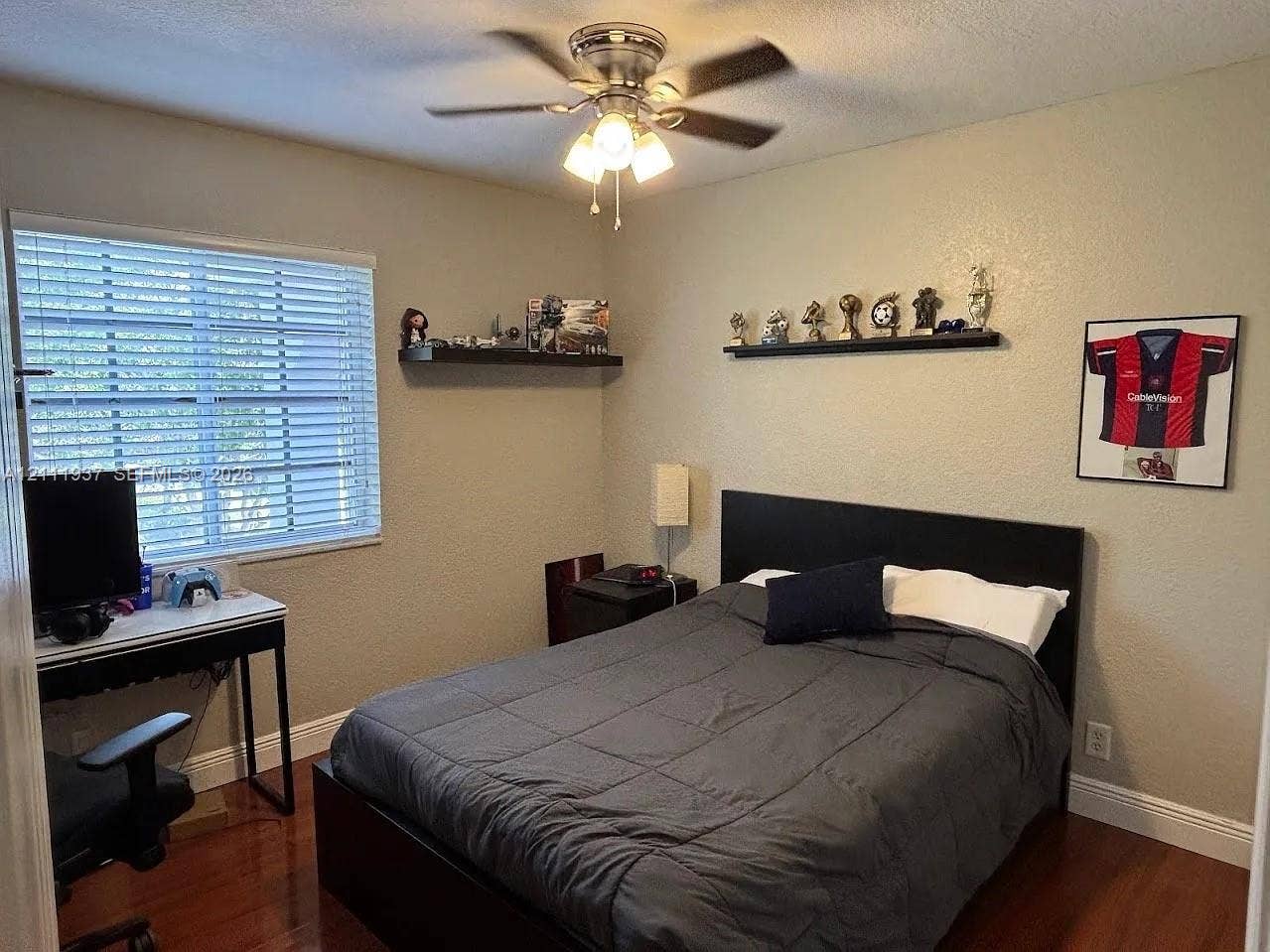 869 Nandina Drive, #869, Weston, Weston, FL 33327 Wood-finish flooring, ceiling fan with integrated light fixture, two mounted wall shelves, and windows featuring horizontal blinds