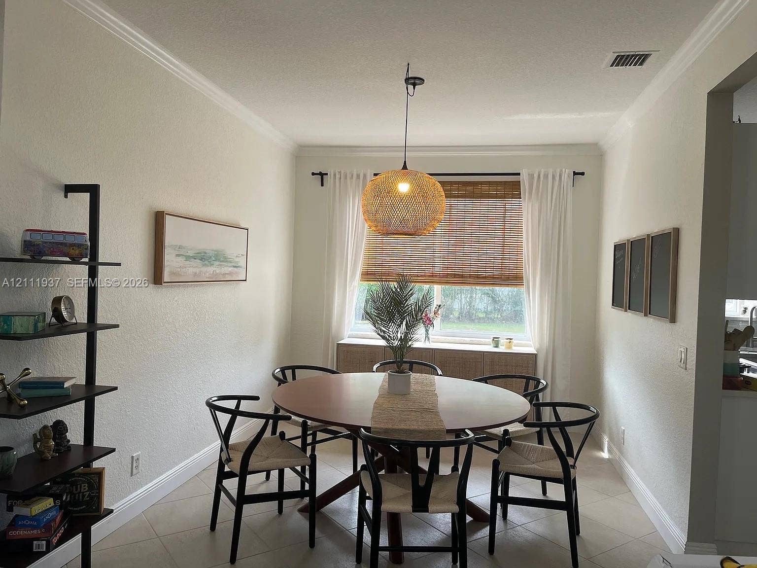 869 Nandina Drive, #869, Weston, Weston, FL 33327 Neutral interior space featuring tile flooring, crown molding, a woven pendant light fixture, and a window with a woven bamboo shade