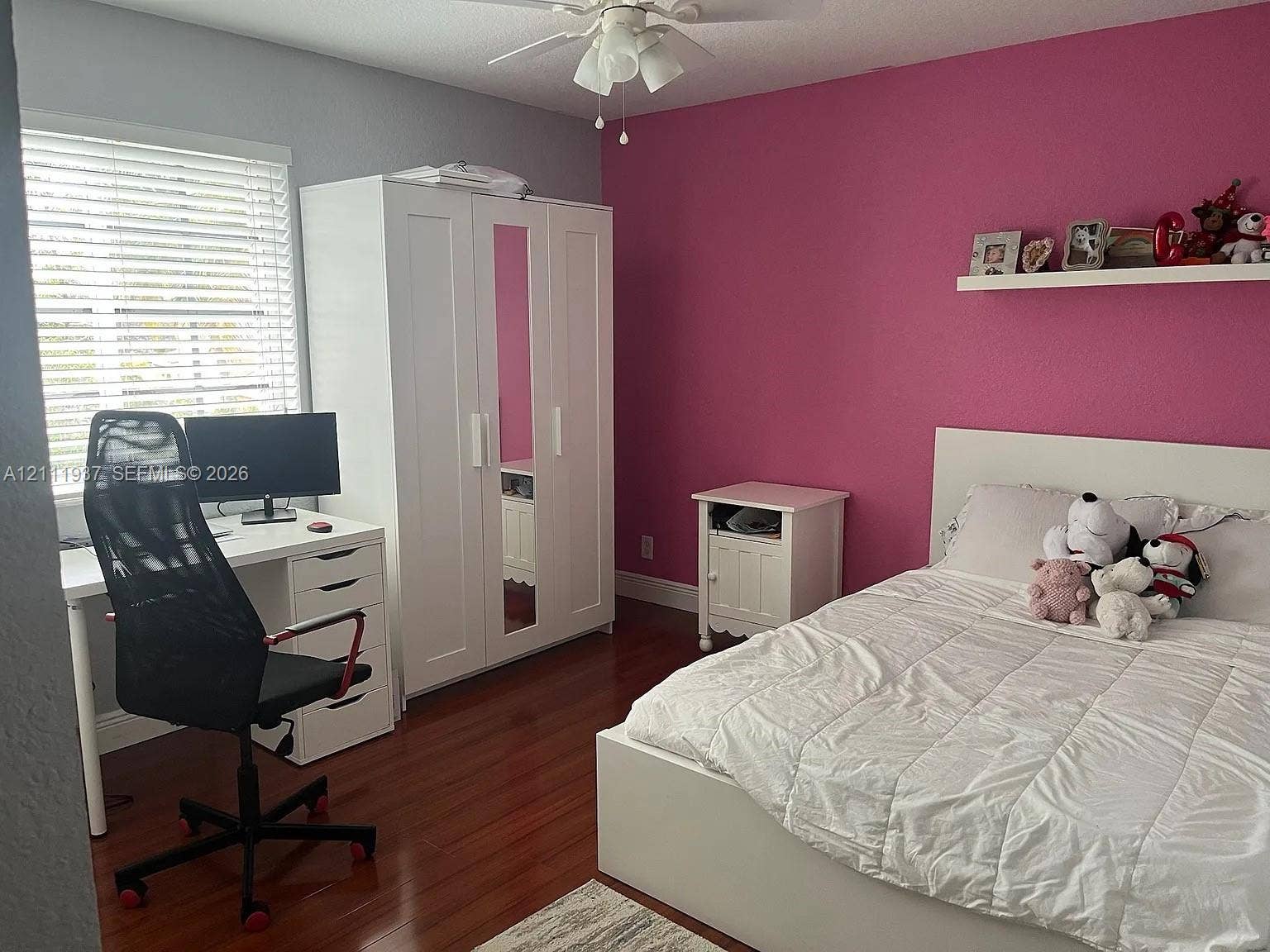 869 Nandina Drive, #869, Weston, Weston, FL 33327 Wood-finish flooring, white built-in armoire with mirrored door, wall-mounted display shelf, and horizontal window blinds