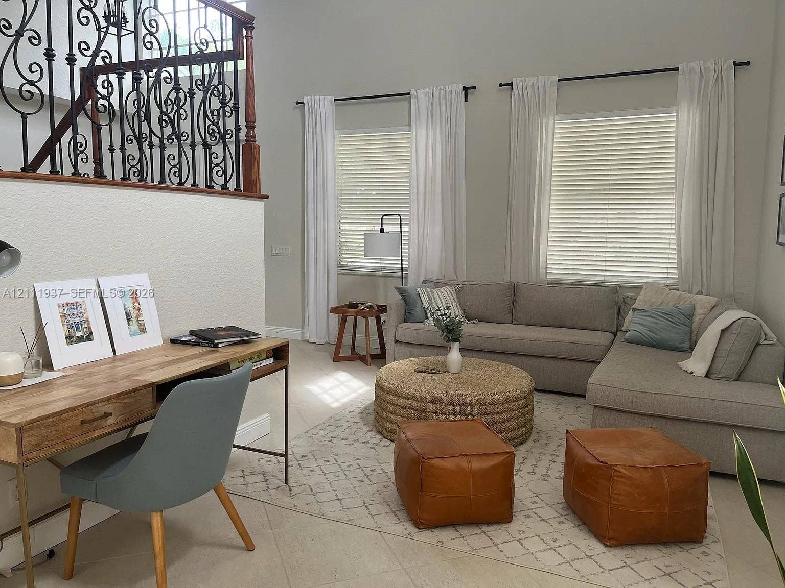 869 Nandina Drive, #869, Weston, Weston, FL 33327 Double-height ceilings, wrought iron staircase railing with a wood handrail, neutral ceramic tile flooring, and large windows with horizontal blinds