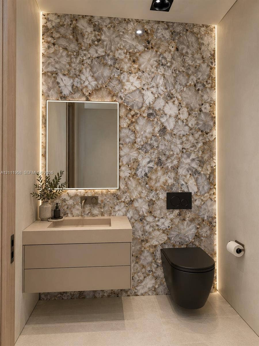 1117 NE 2nd Street, Fort Lauderdale, FL 33301 Feature wall with backlighting, wall-mounted floating vanity, integrated rectangular basin, wall-mounted faucet, and wall-mounted toilet