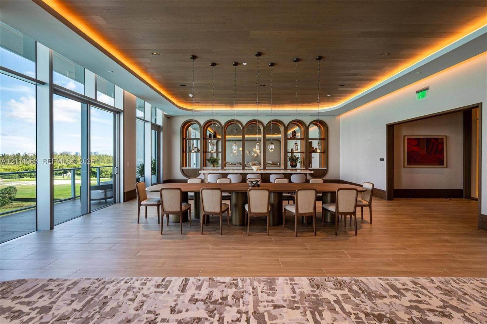 Living area featuring wood-finish flooring, ceiling with exposed beams, recessed lighting, built-in wooden cabinetry, and floor-to-ceiling glass wall panels