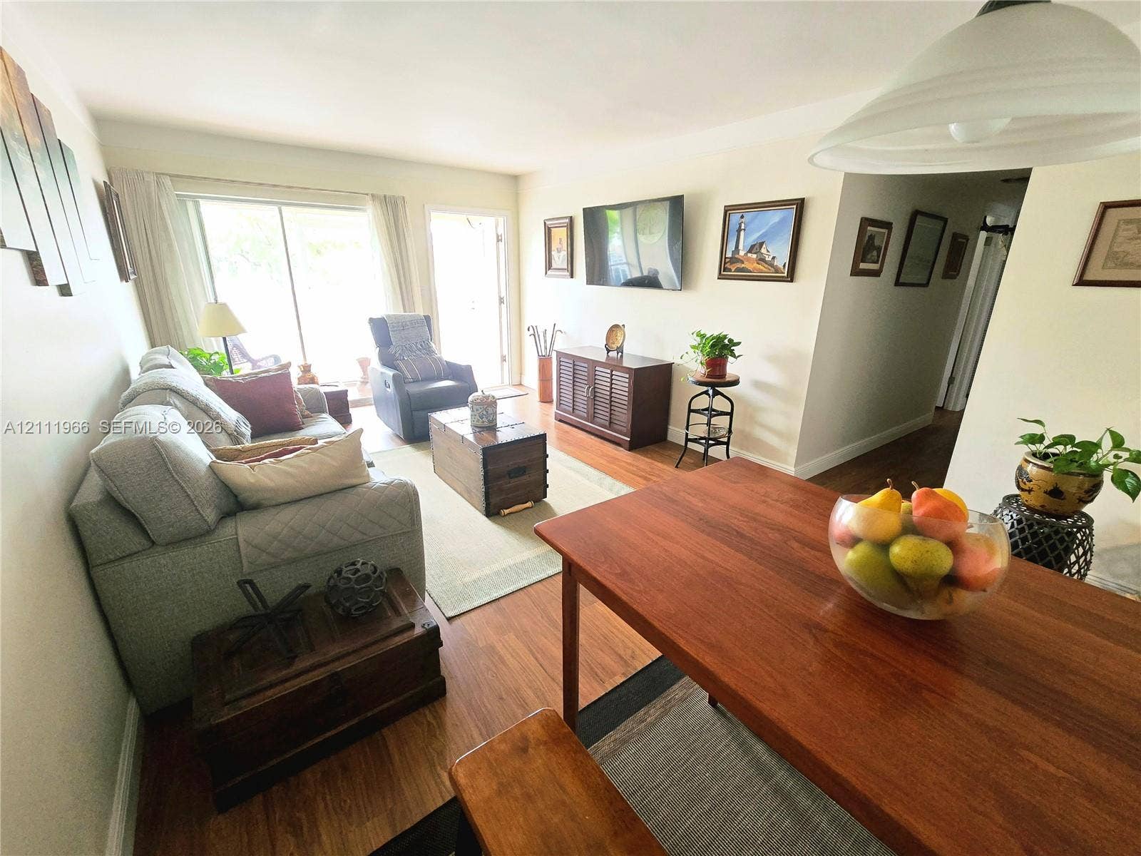 5387 SW 40th Avenue, #203, Dania Beach, FL 33314 Living area featuring wood-finish flooring, sliding glass patio door, and recessed lighting
