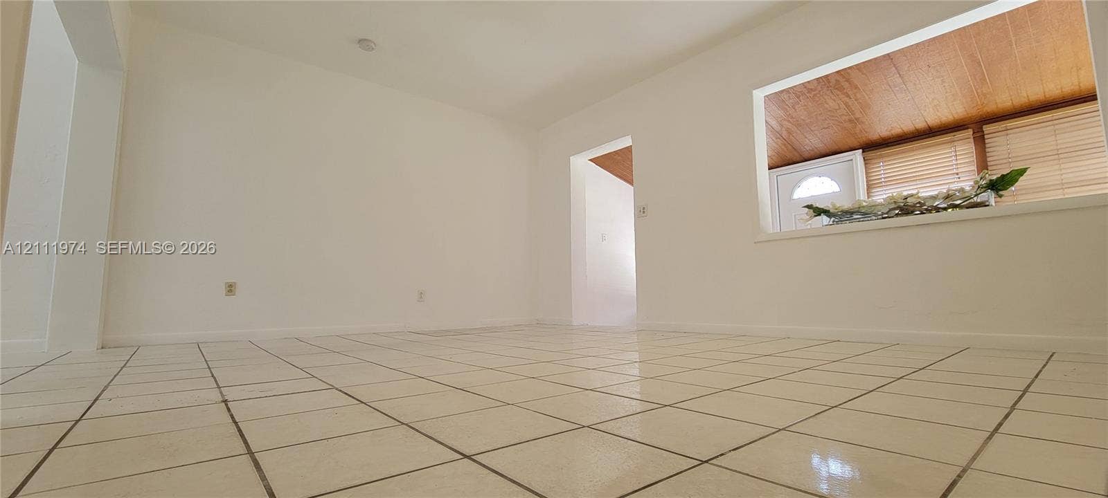 600 SW 44th Court, Miami, Miami, FL 33134 Interior space featuring white walls, square ceramic tile flooring, and a large pass-through opening