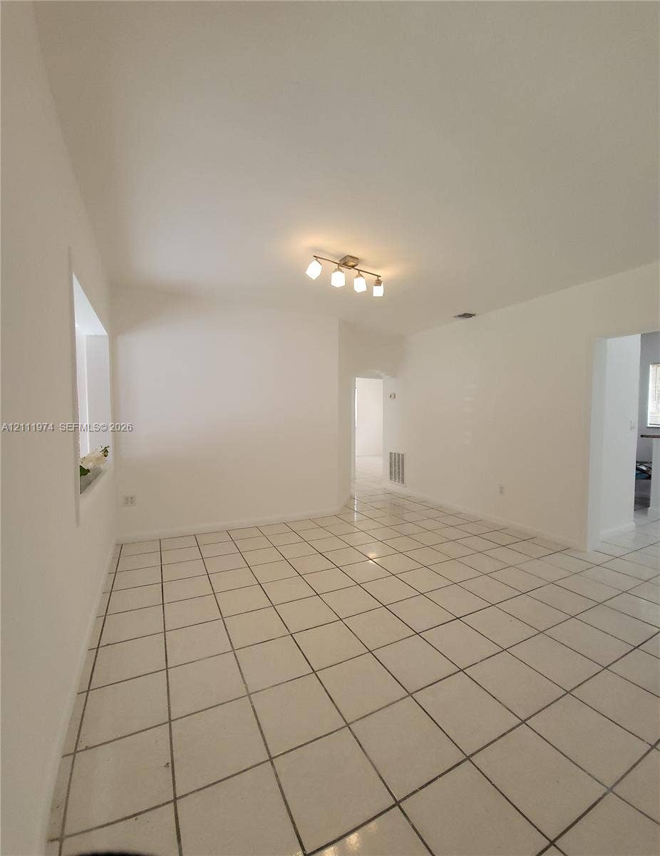 600 SW 44th Court, Miami, Miami, FL 33134 Neutral-toned interior featuring square ceramic floor tiling, smooth walls, and a four-light ceiling-mounted fixture