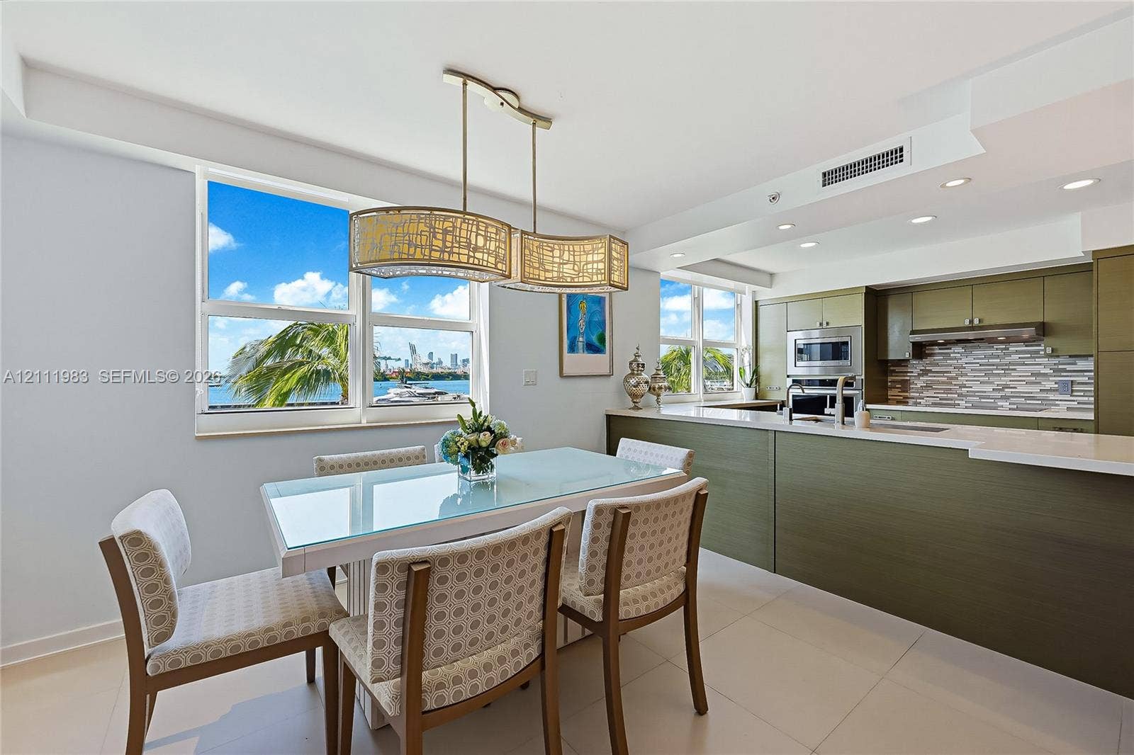 90 Alton Road, #TH-8, Miami Beach, FL 33139 Kitchen featuring olive-toned cabinetry, quartz countertops, a multi-textured stone backsplash, built-in stainless steel appliances, and large-format tile flooring
