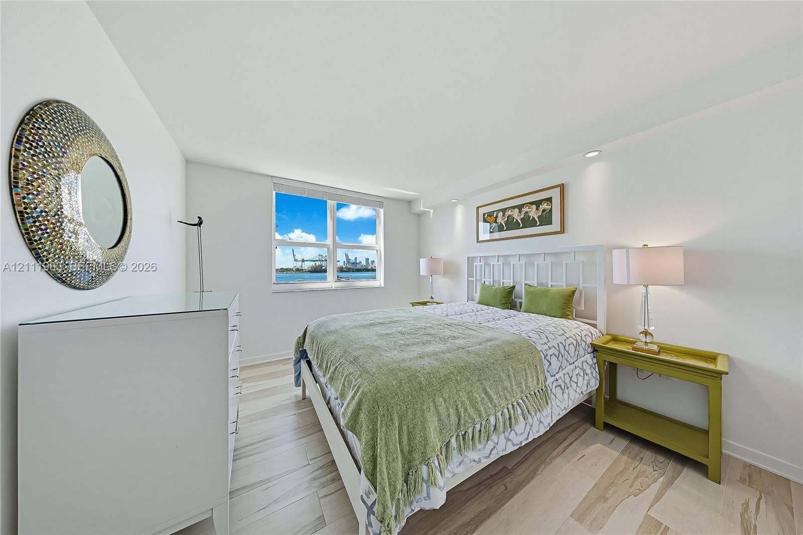 90 Alton Road, #TH-8, Miami Beach, FL 33139 Interior space featuring light-toned tile flooring, recessed ceiling lighting, and window with water and skyline scenery