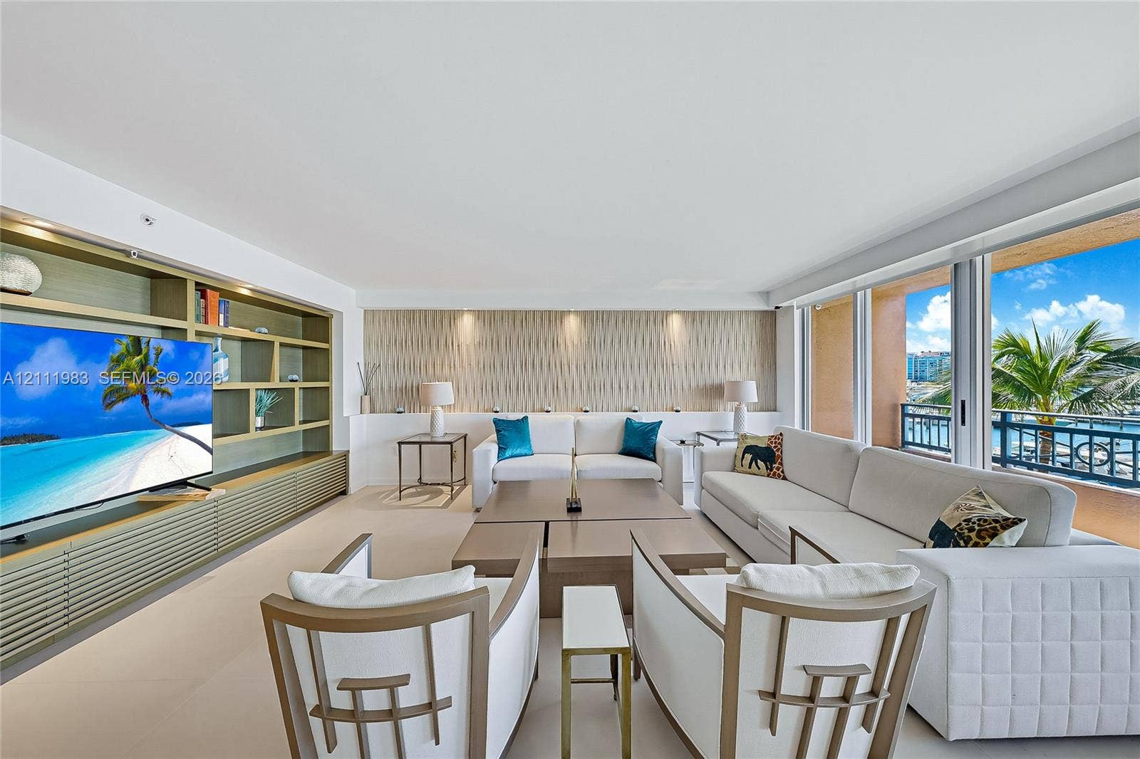 90 Alton Road, #TH-8, Miami Beach, FL 33139 Living area featuring floor-to-ceiling glass sliding doors, built-in floor-to-ceiling shelving, recessed lighting, and textured accent wall paneling