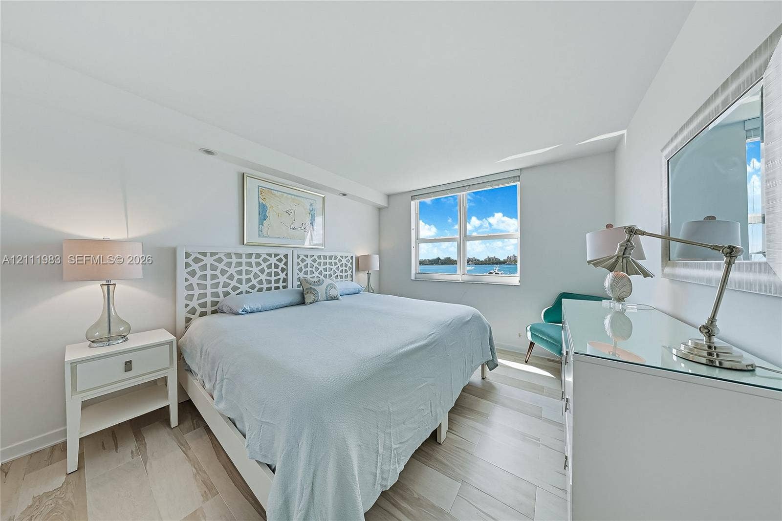 90 Alton Road, #TH-8, Miami Beach, FL 33139 Neutral-toned wood-finish flooring and large window with exterior water exposure