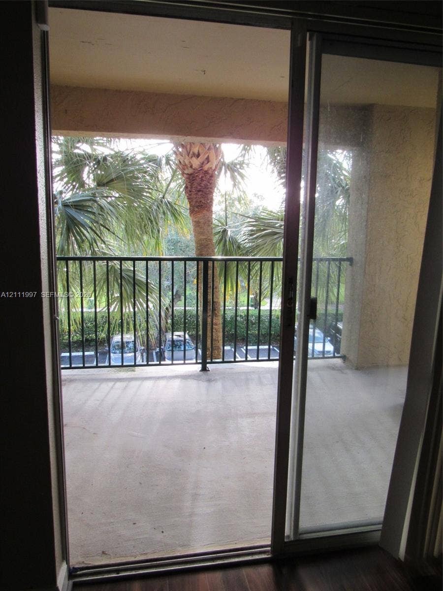 733 Riverside Drive, #1232, Coral Springs, Coral Springs, FL 33071 Covered balcony featuring concrete flooring and black metal railing