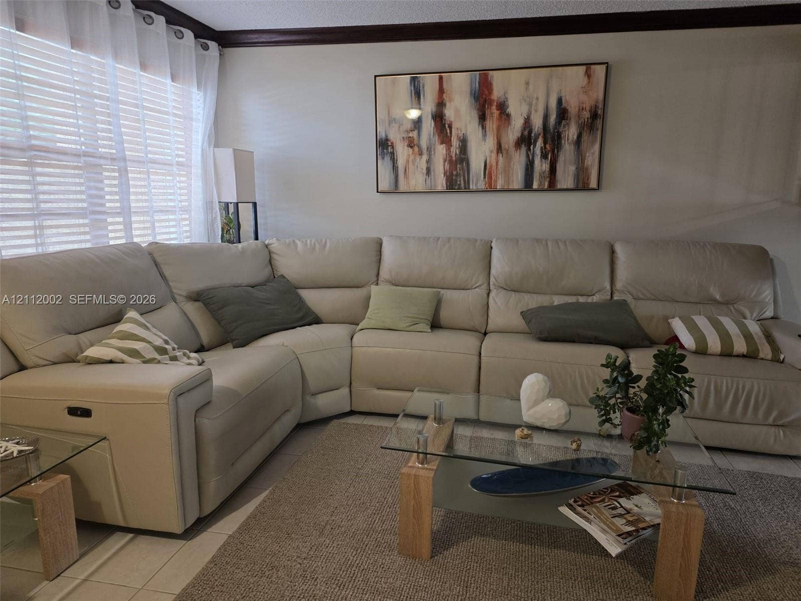 Interior room featuring neutral wall paint, multi-paned window, and dark crown molding