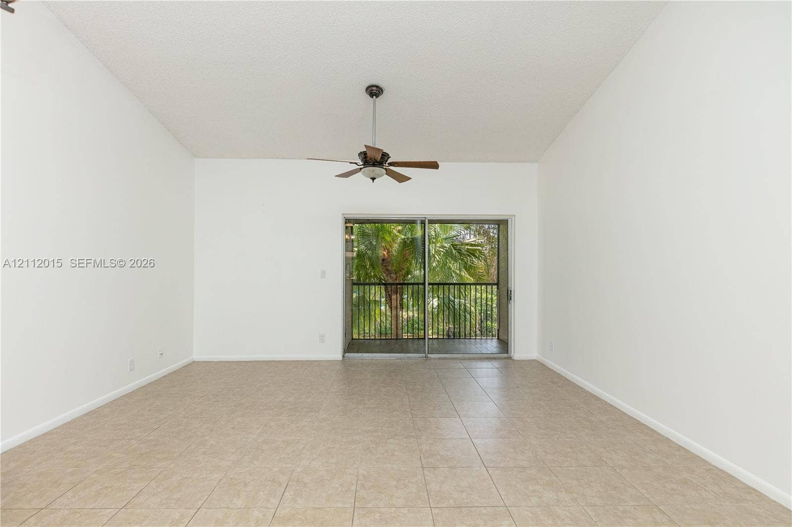 717 Gardens Drive, #201, Pompano Beach, Pompano Beach, FL 33069 Vaulted ceilings, ceramic tile flooring, ceiling fan, and sliding glass doors with access to an outdoor balcony