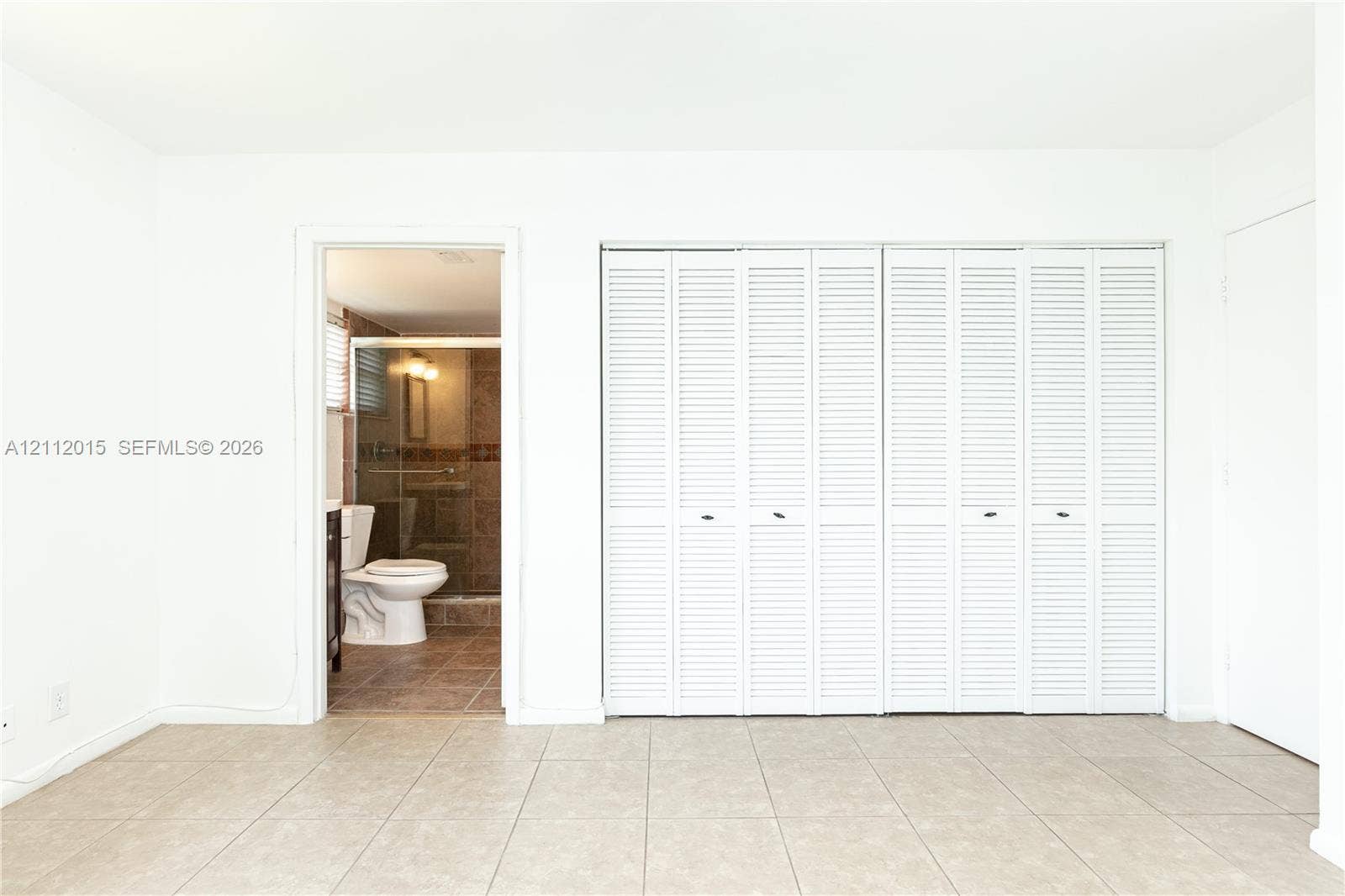 717 Gardens Drive, #201, Pompano Beach, Pompano Beach, FL 33069 Room featuring tile flooring and white louvered bifold closet doors