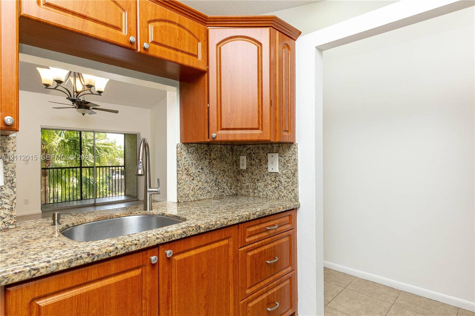 717 Gardens Drive, #201, Pompano Beach, Pompano Beach, FL 33069 Kitchen featuring wood cabinetry, stone-finish countertops, stainless steel undermount sink, and high-arc pull-down faucet