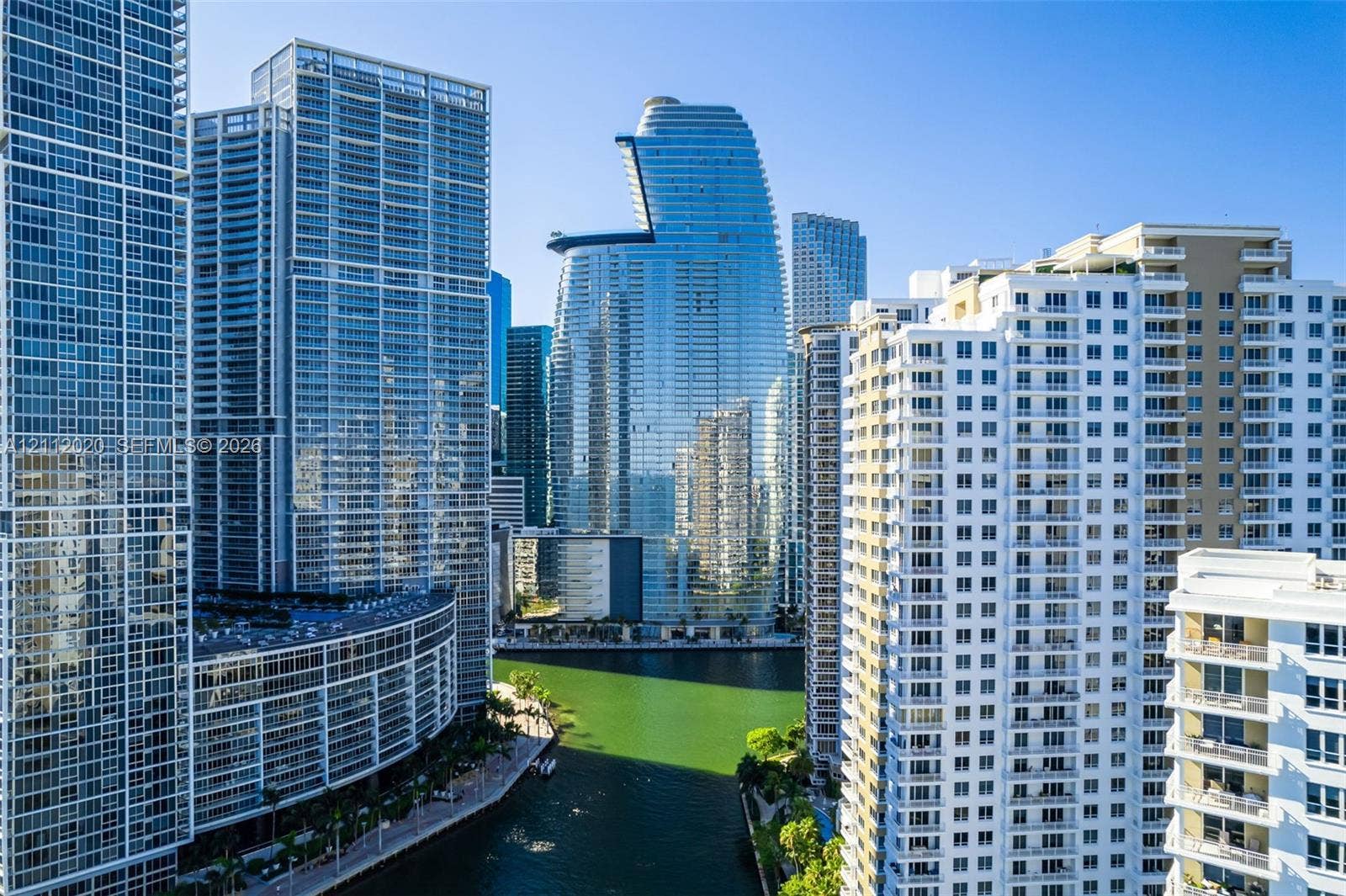 300 Biscayne Blvd Way, #4202, Miami, Miami, FL 33131 High-rise urban setting featuring reflective glass facades, balconies, waterfront access, and dense metropolitan architecture