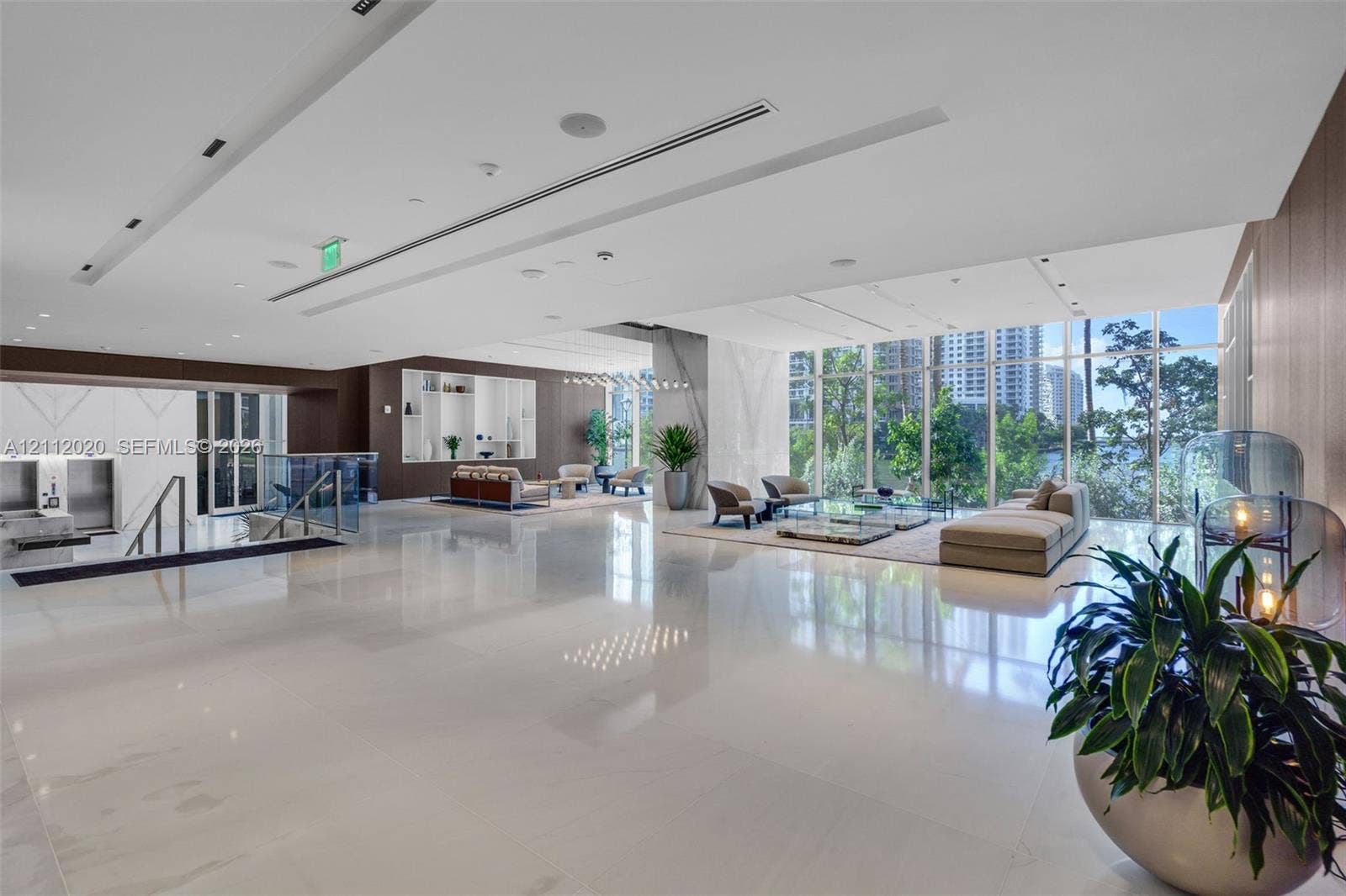 300 Biscayne Blvd Way, #4202, Miami, Miami, FL 33131 Spacious lobby featuring polished stone flooring, floor-to-ceiling windows, recessed architectural ceiling lighting, and built-in wall niches