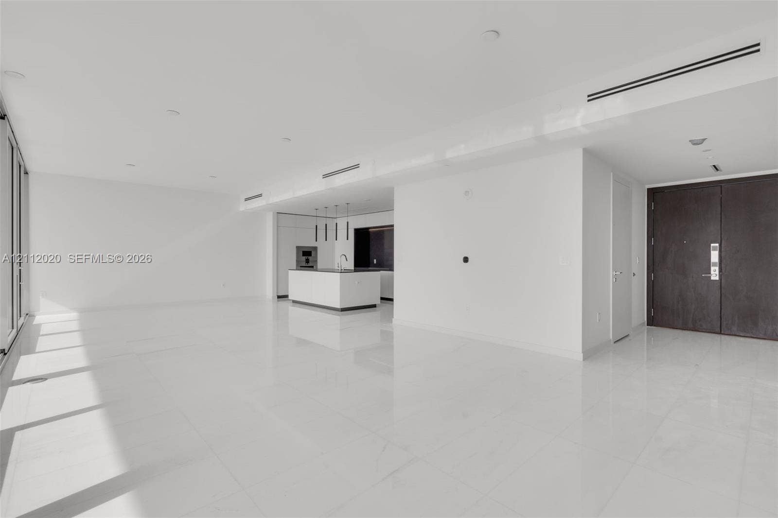 300 Biscayne Blvd Way, #4202, Miami, Miami, FL 33131 Open-concept interior featuring large-format tile flooring, recessed ceiling lighting, linear air diffusers, a kitchen island with built-in cabinetry, and a dark-finish double-door entry