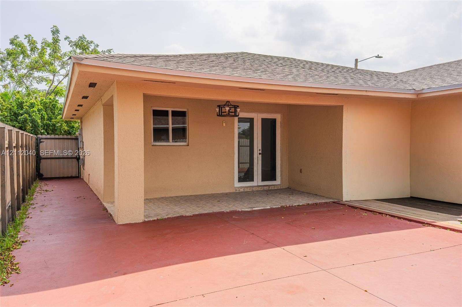 Covered patio featuring a paved floor, built-in overhead lighting, and double-glass door entry