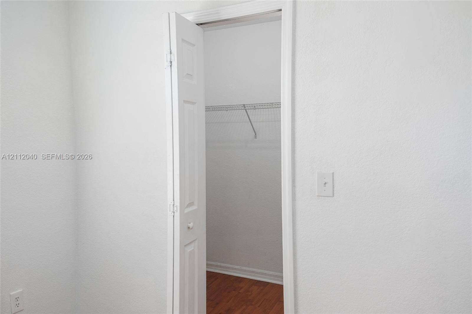 Closet featuring bi-fold doors, white interior walls, and wire shelving