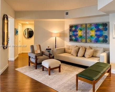 Wood-finish flooring, neutral wall tones, and recessed ceiling lighting