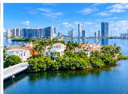 Waterfront estate featuring deep-water access, multi-story Mediterranean-style architecture, tile roofing, private bridge entry, and mature tropical landscaping