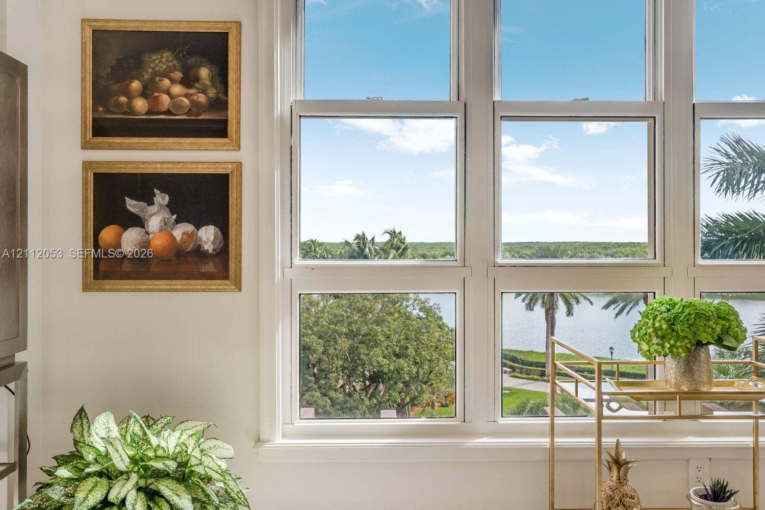Multi-pane white-trimmed windows offering expansive water and landscape scenery