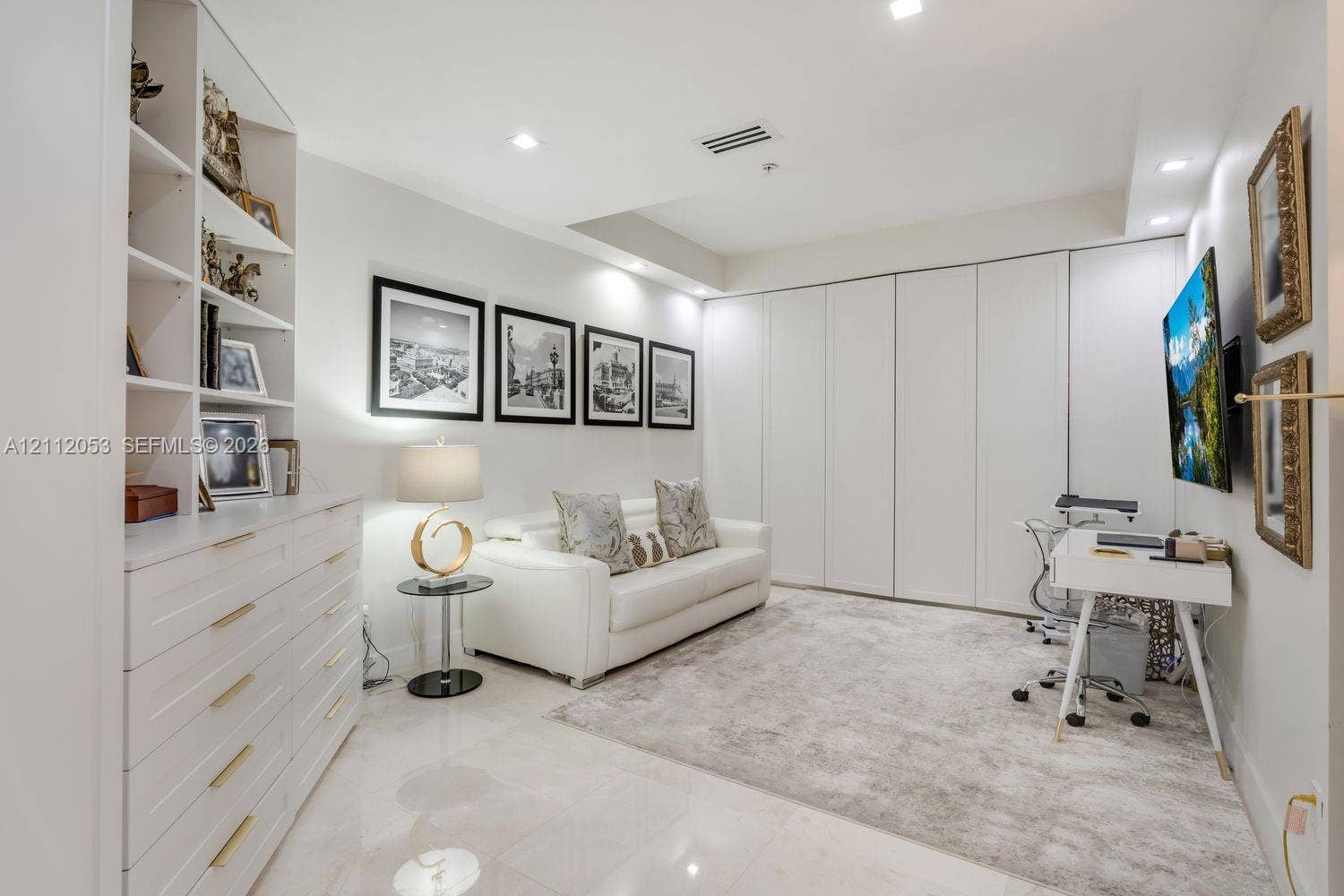 Built-in floor-to-ceiling cabinetry, recessed lighting, polished stone-finish flooring, and full-wall integrated wardrobe closets with seamless doors