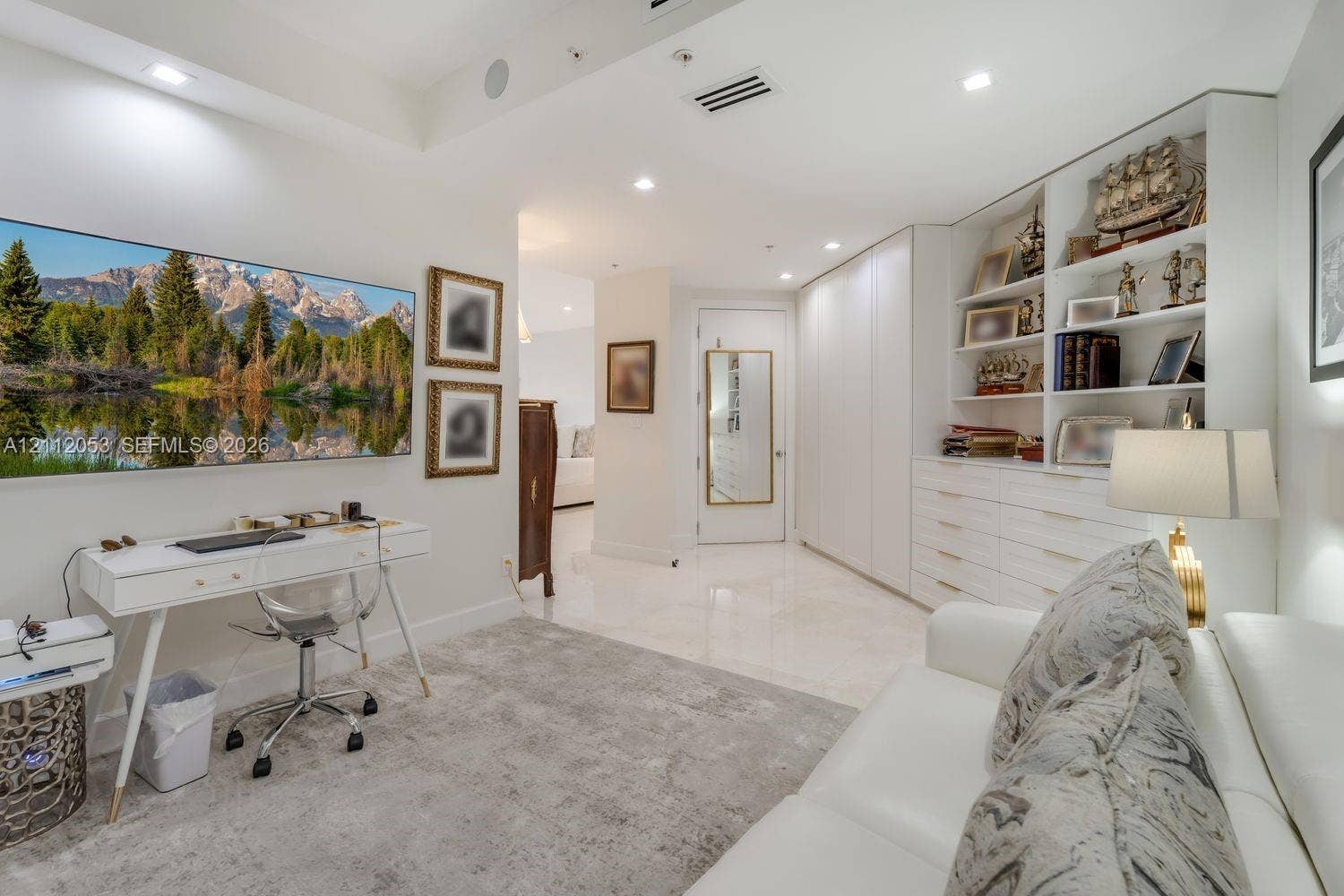 Custom floor-to-ceiling cabinetry featuring integrated shelving and storage drawers, recessed lighting, and stone-finish flooring