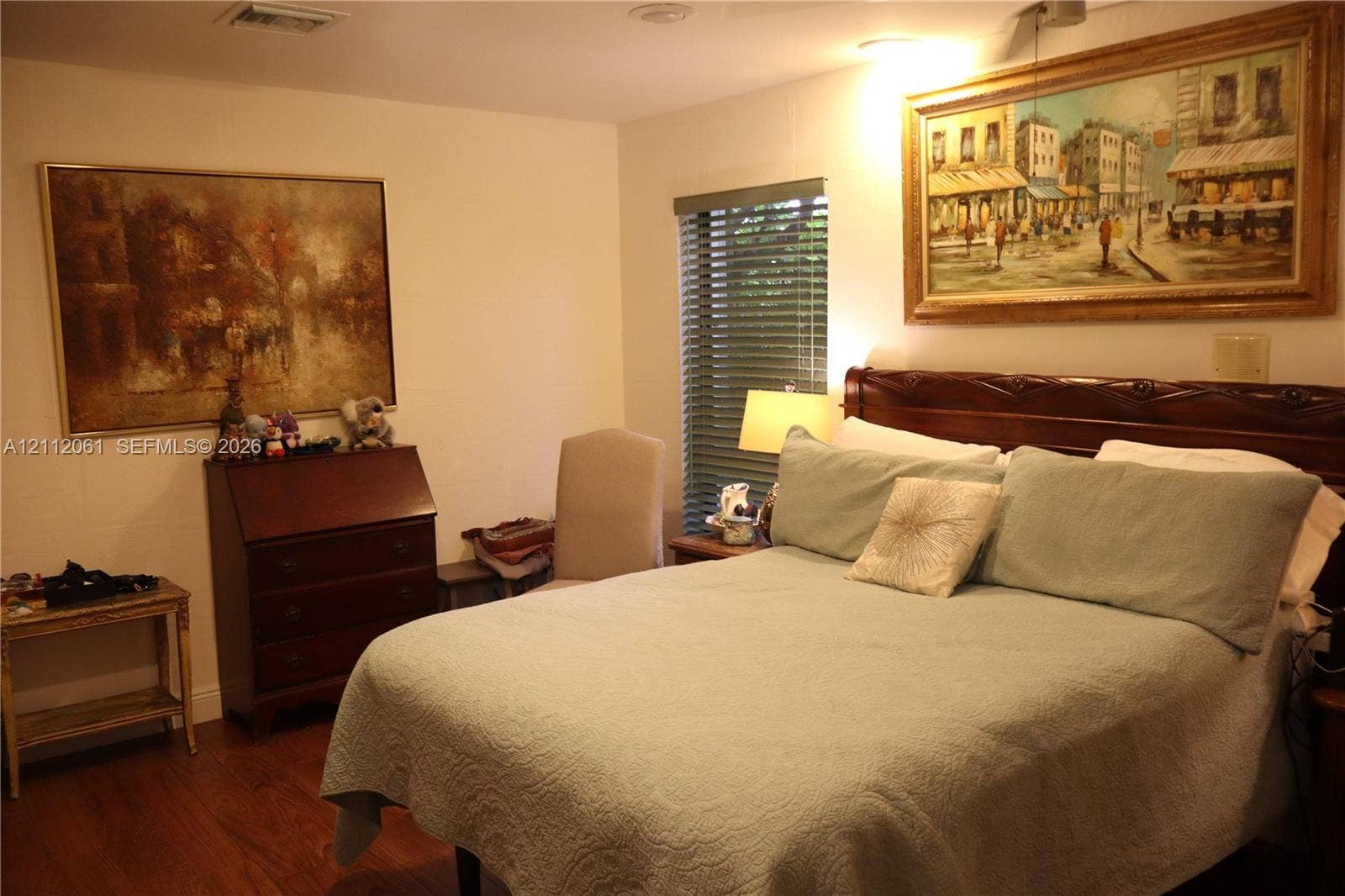 17191 SW Shaddock Lane, Boca Raton, FL 33487 Interior room featuring wood-finish flooring and horizontal window blinds