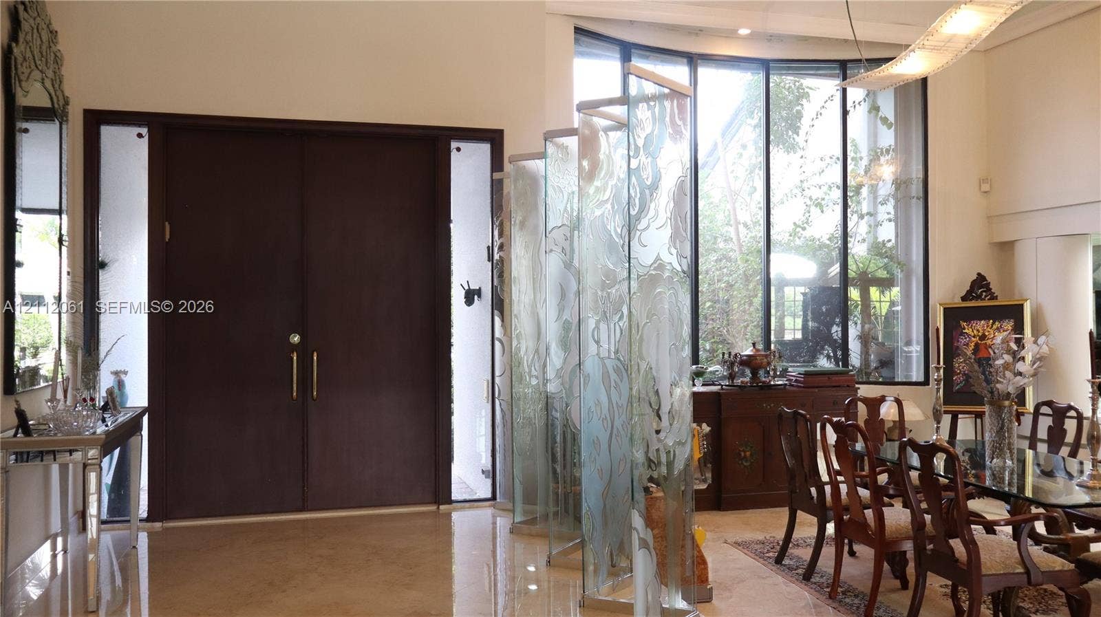 17191 SW Shaddock Lane, Boca Raton, FL 33487 Double-door entry with sidelights, high ceilings, expansive floor-to-ceiling curved windows, and decorative frosted glass panels