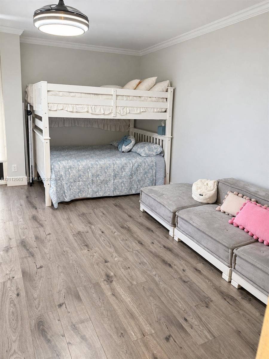 1360 S Ocean Boulevard, #2503, Pompano Beach, Pompano Beach, FL 33062 Room featuring wood-finish flooring, crown molding, and a contemporary circular flush-mount ceiling light fixture