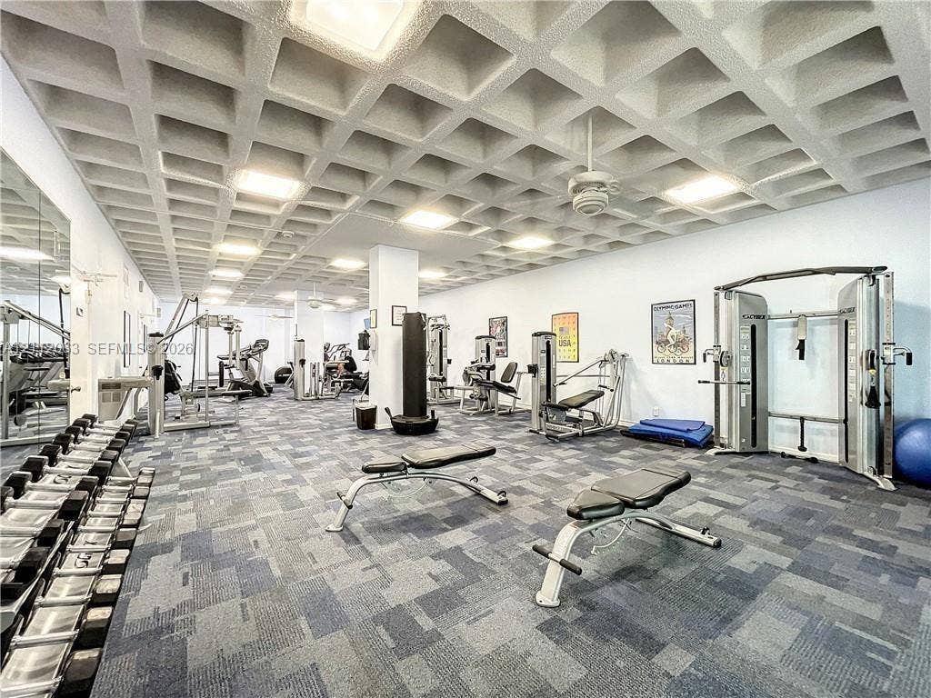 1360 S Ocean Boulevard, #2503, Pompano Beach, Pompano Beach, FL 33062 Spacious recreation room featuring a geometric coffered ceiling, inset recessed lighting, expansive wall-to-wall mirrors, and industrial-grade carpeting